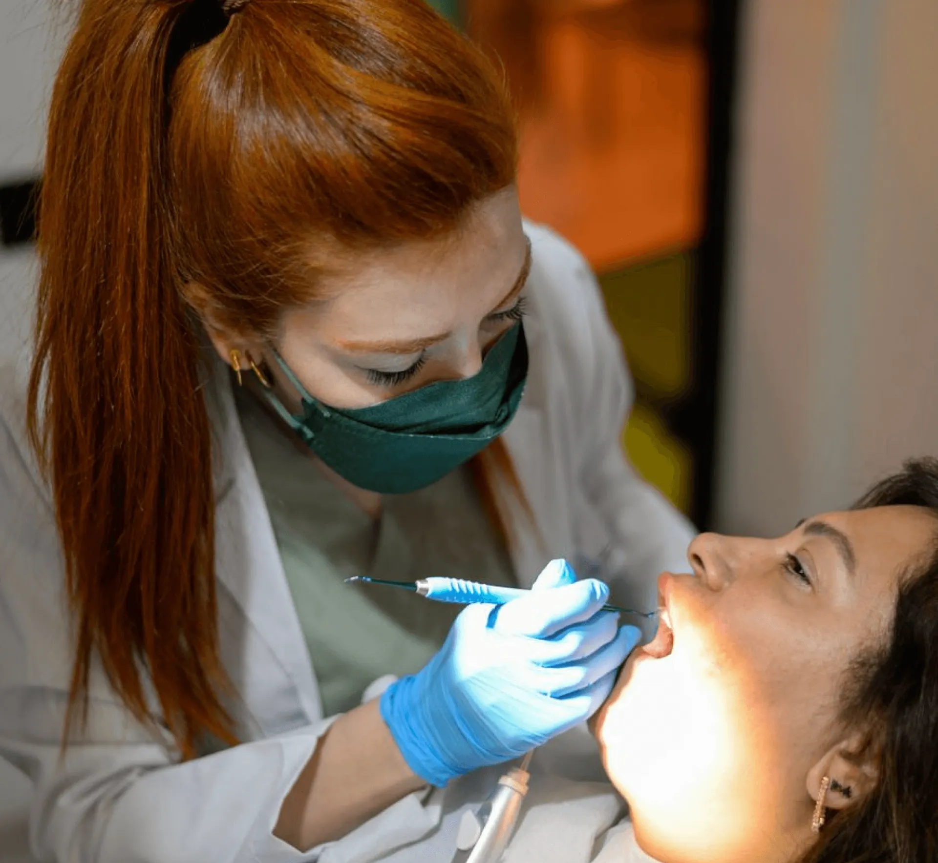 Female Dentists treating the patient's teeth