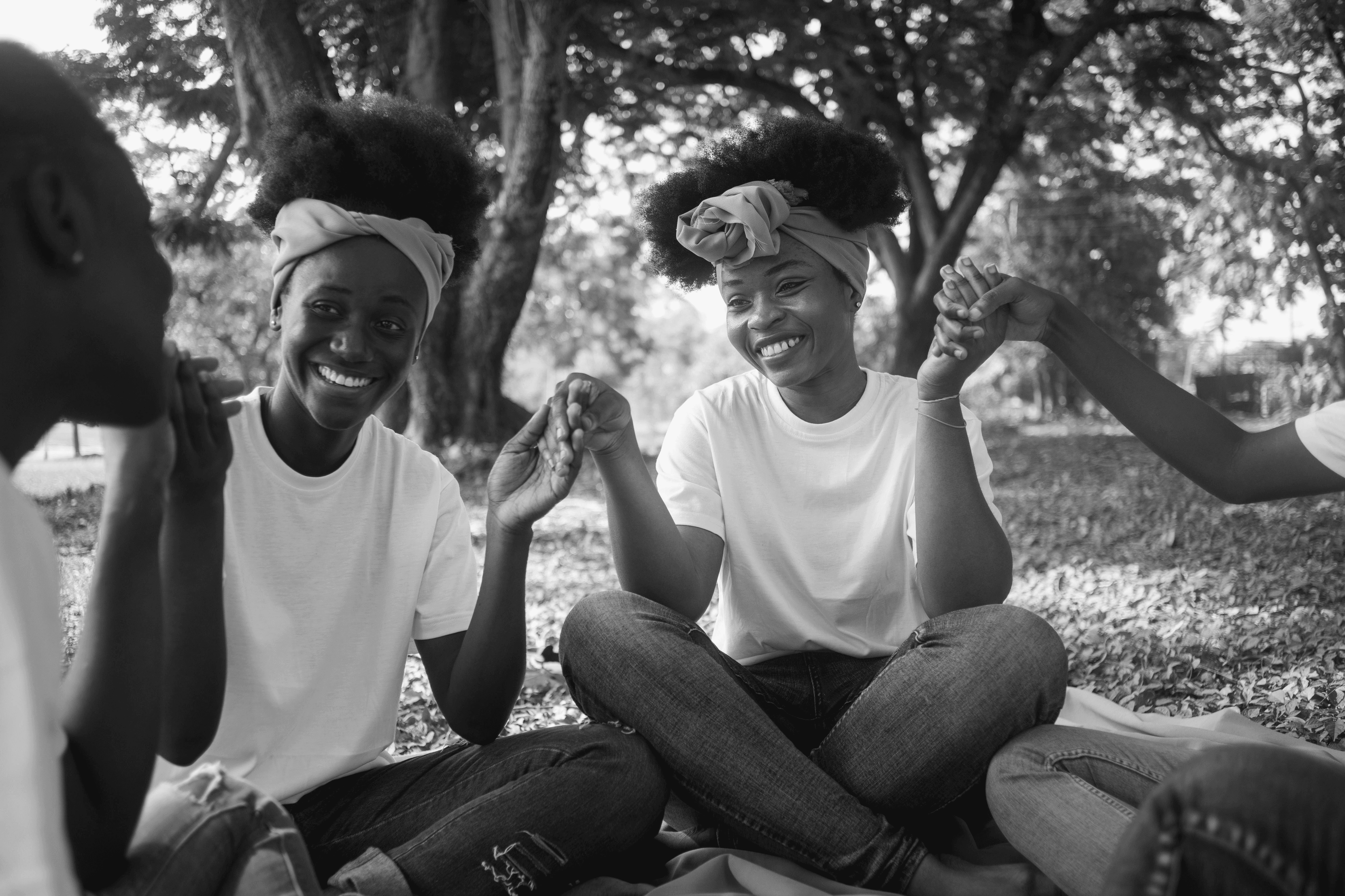 five children smiling while doing peace hand sign