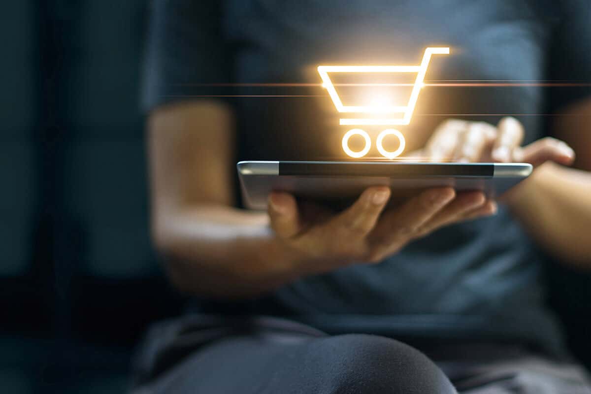 Futuristic shopper graphic with laptop and shopping cart icon