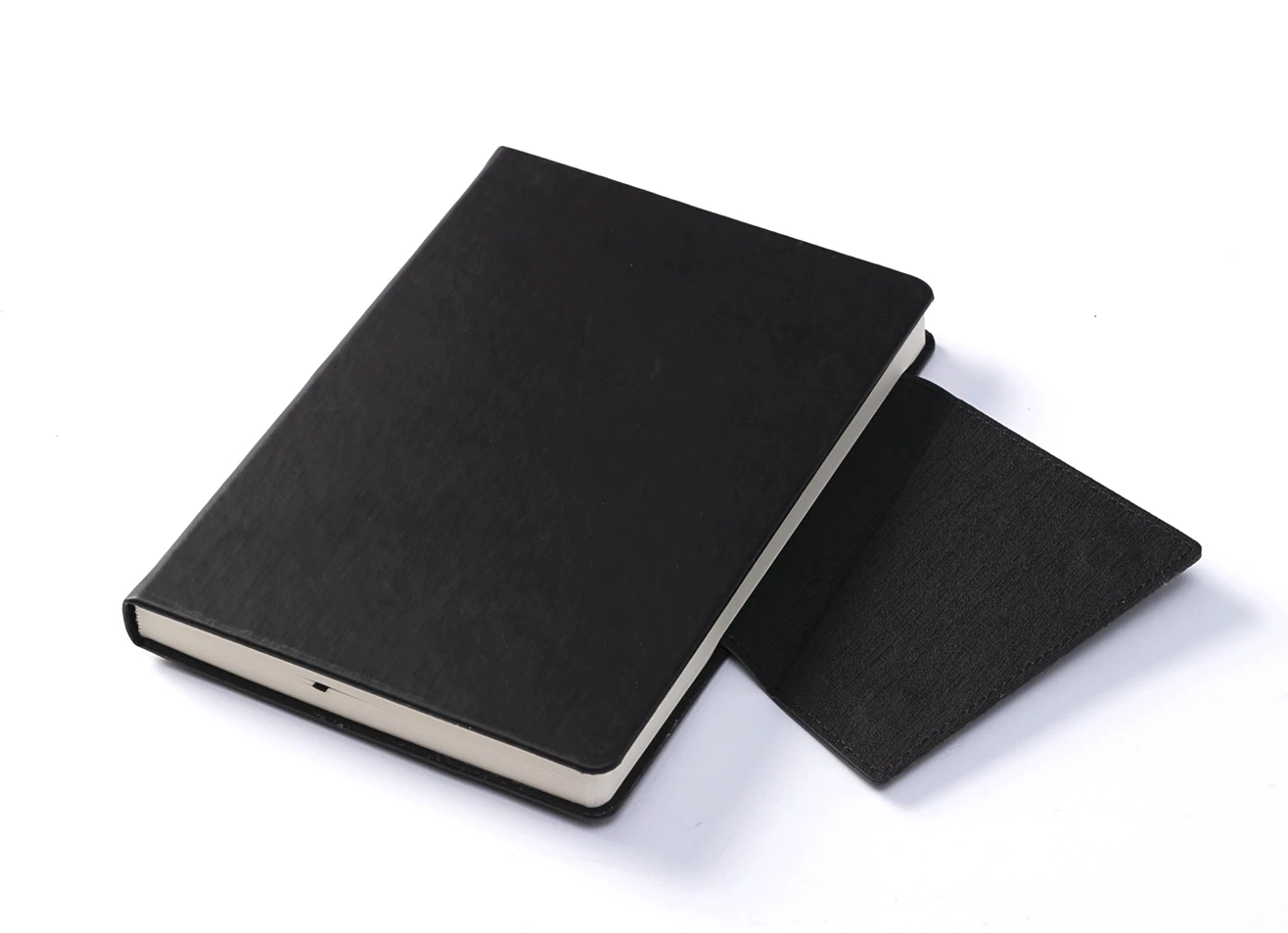 Angled view of black notebook with open magnetic flap.