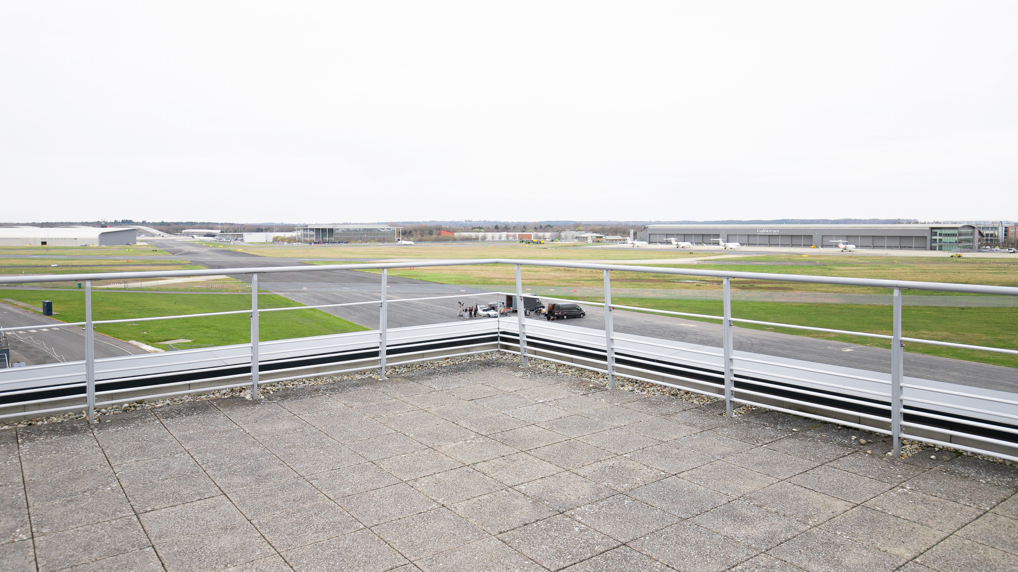 Two classic volkswagen beetles, one green, one cream.