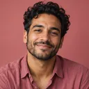 Portrait of Sami, smiling man with dark curly hair