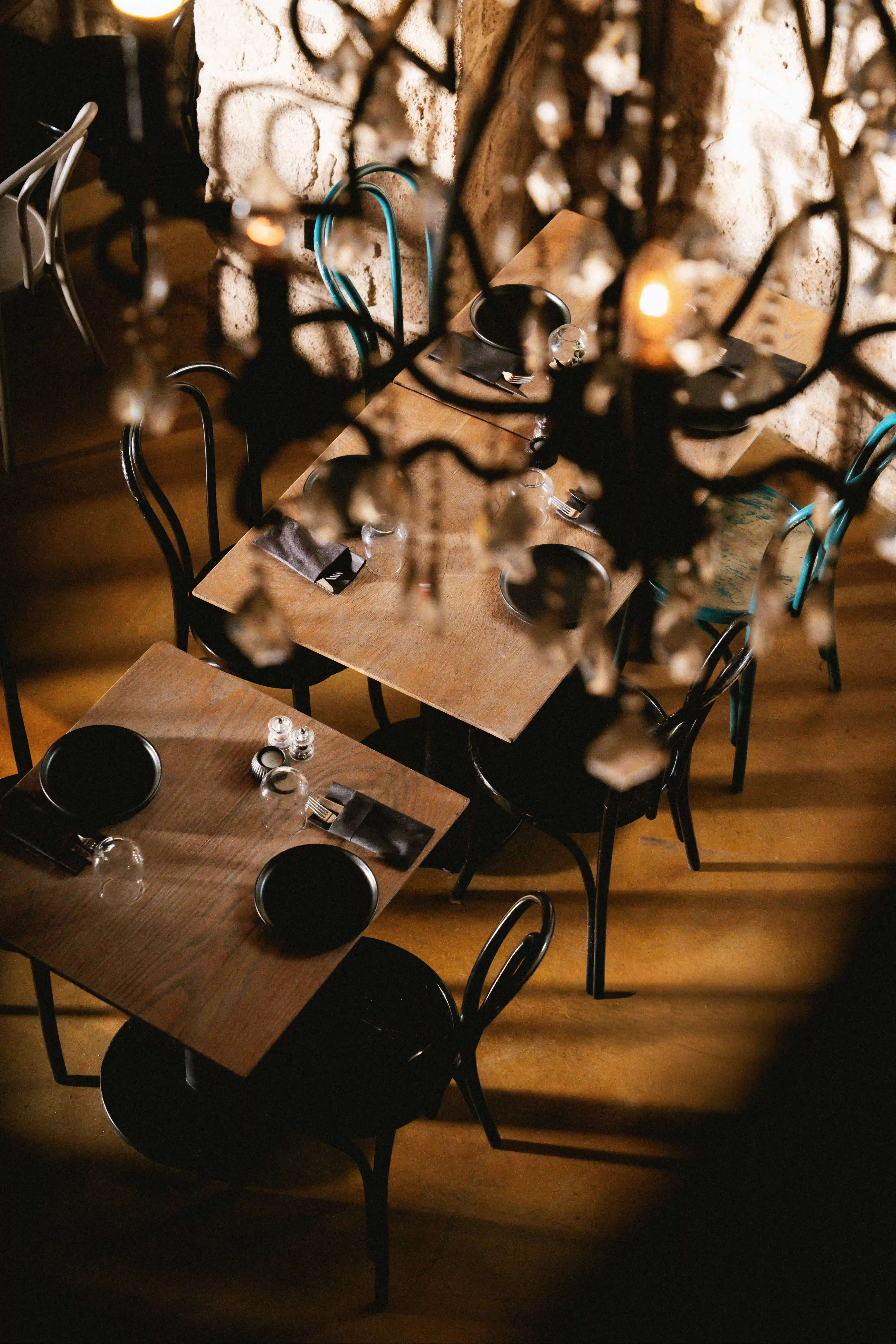 Restaurant bar with guests seated at tables and bartenders at work.
