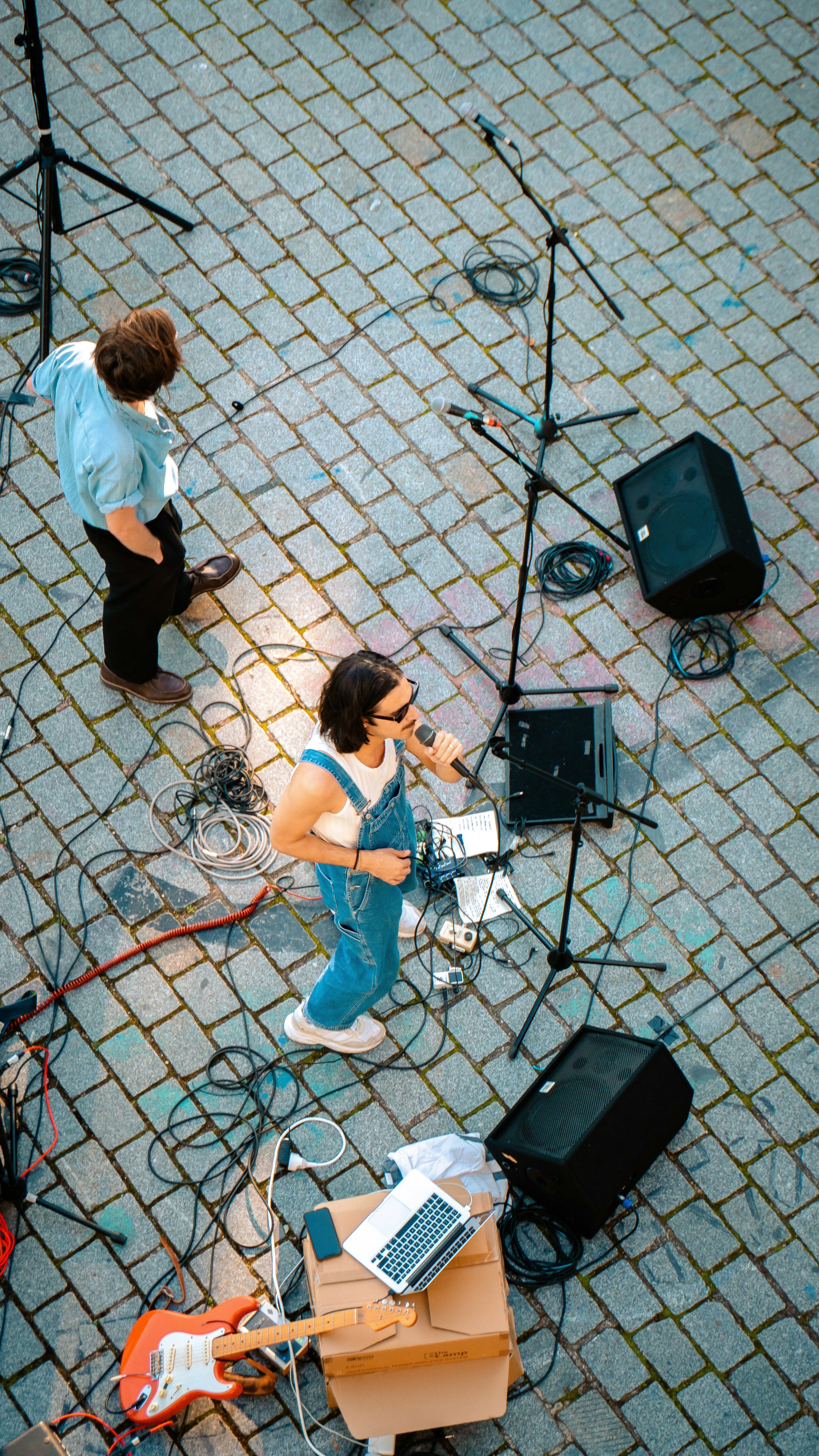 A group of people that are standing on a sidewalk