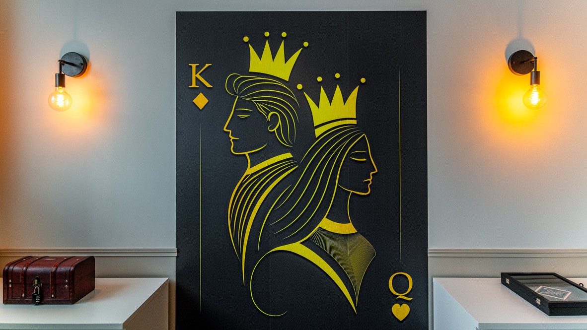 A dark car speeds through a blurry city at night.