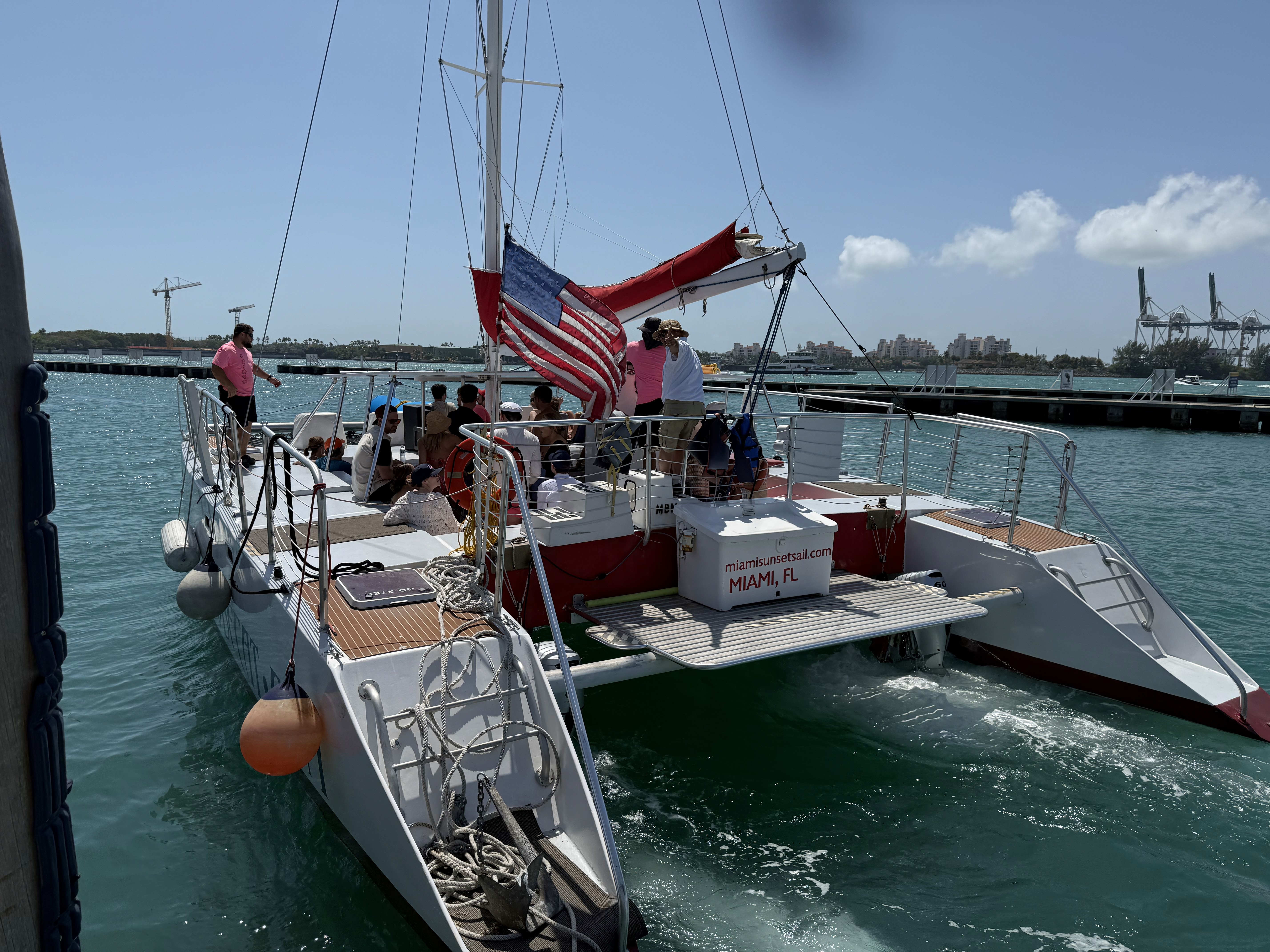 man standing near cliff looking at body of water during daytime