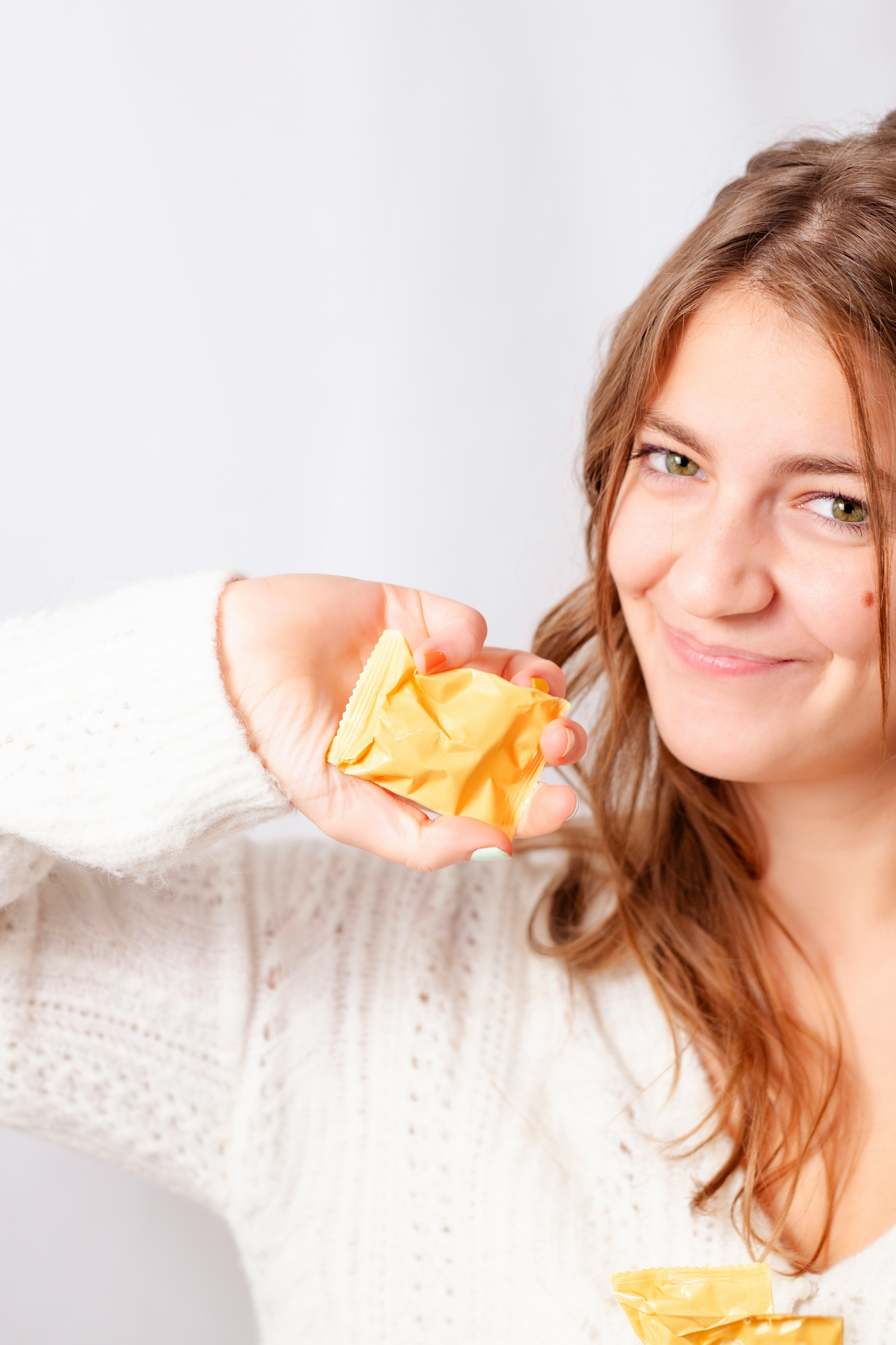 A woman holding a piece of food up to her face
