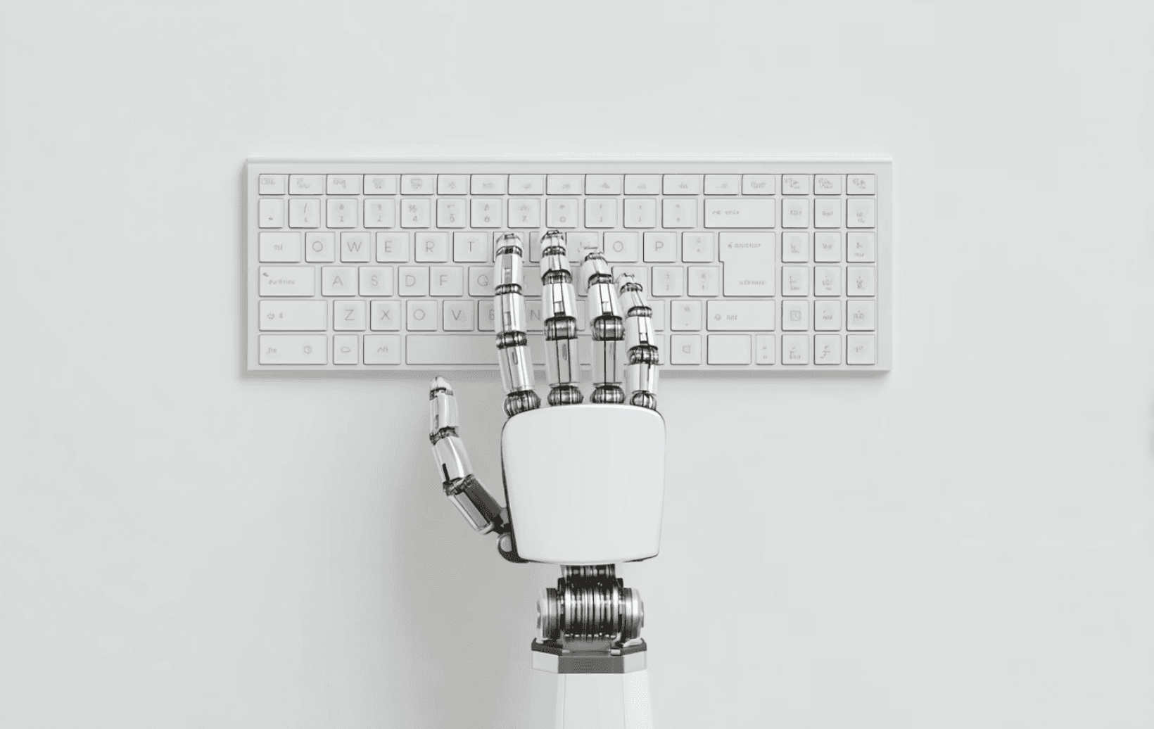 Robotic hand typing on a white keyboard, symbolizing AI and technology.