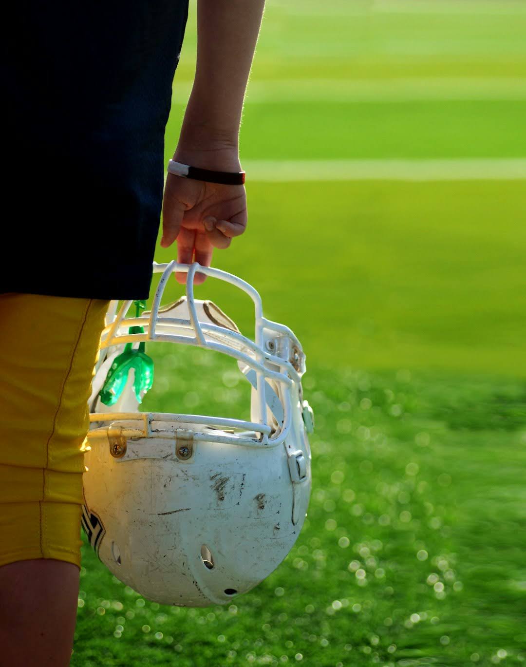 A person proudly holds a football helmet, symbolizing the Patriots' historic comeback in Super Bowl LI.