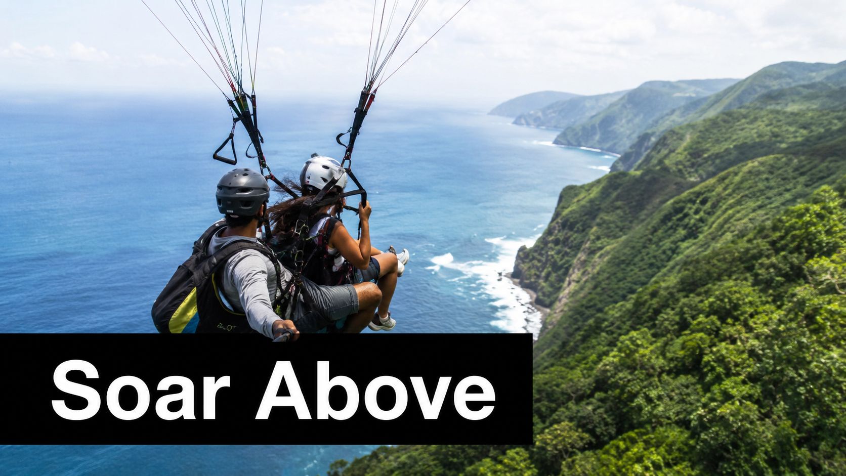 A person paragliding with a partner over the lush green coastline of a tropical island paradise.