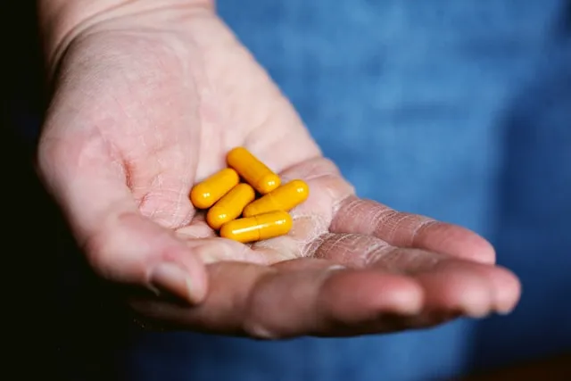 Turmeric / Curcumin pills in a hand