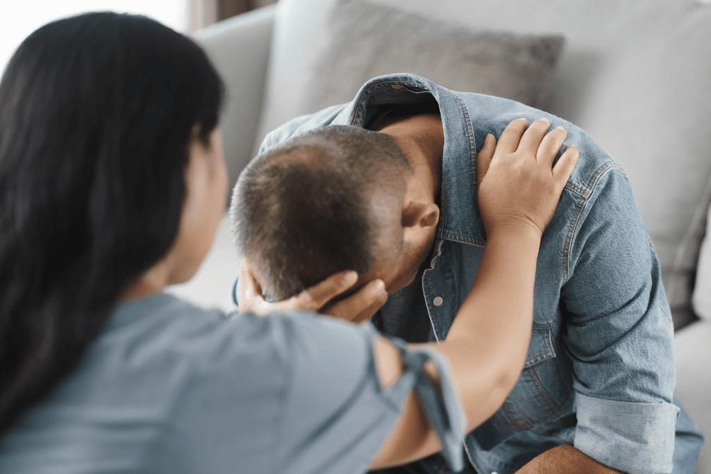 Female psychologist put hands on the shoulder for cheer up to mental depress man