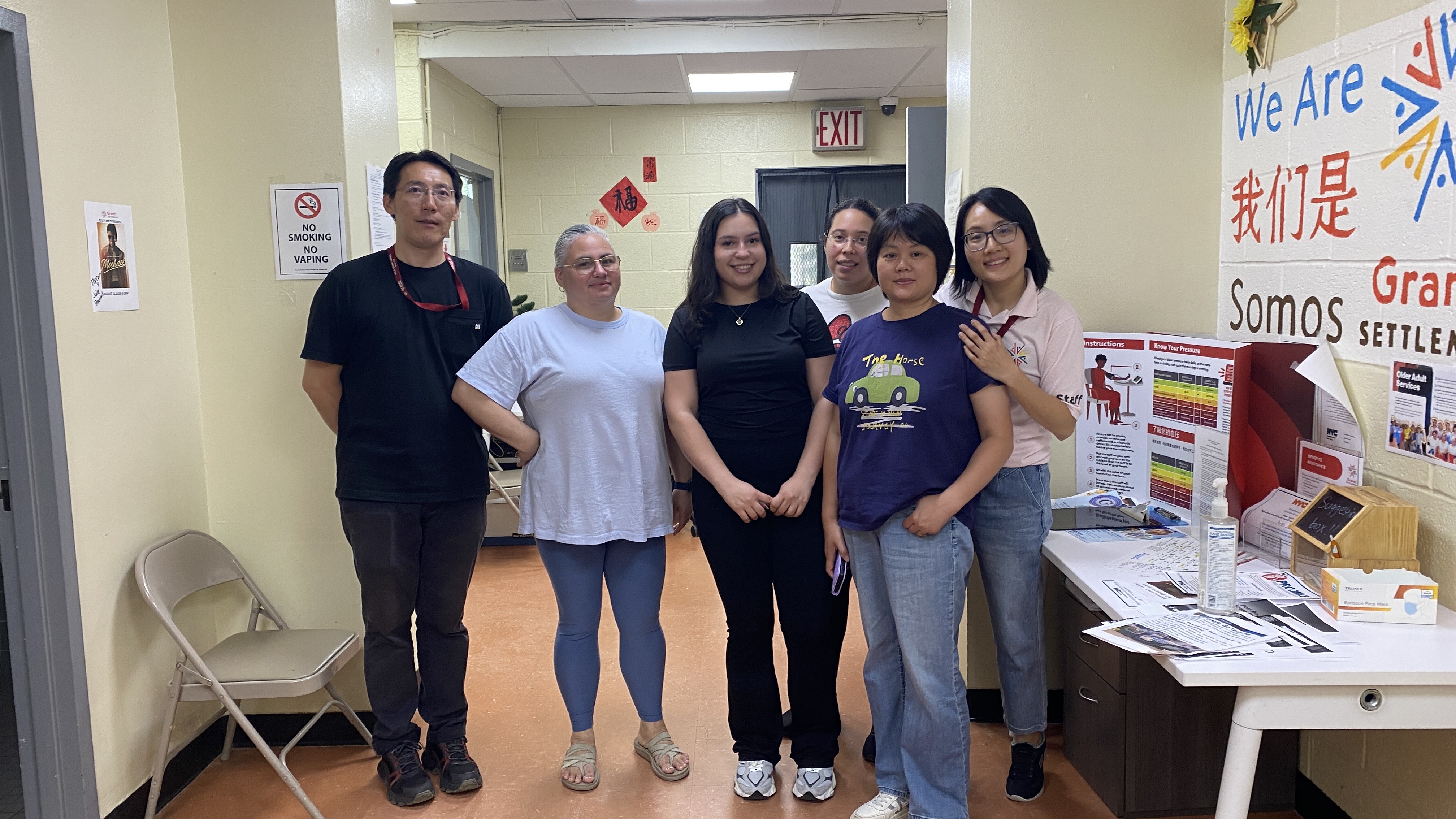 Staff members pose with an intern on her last day.