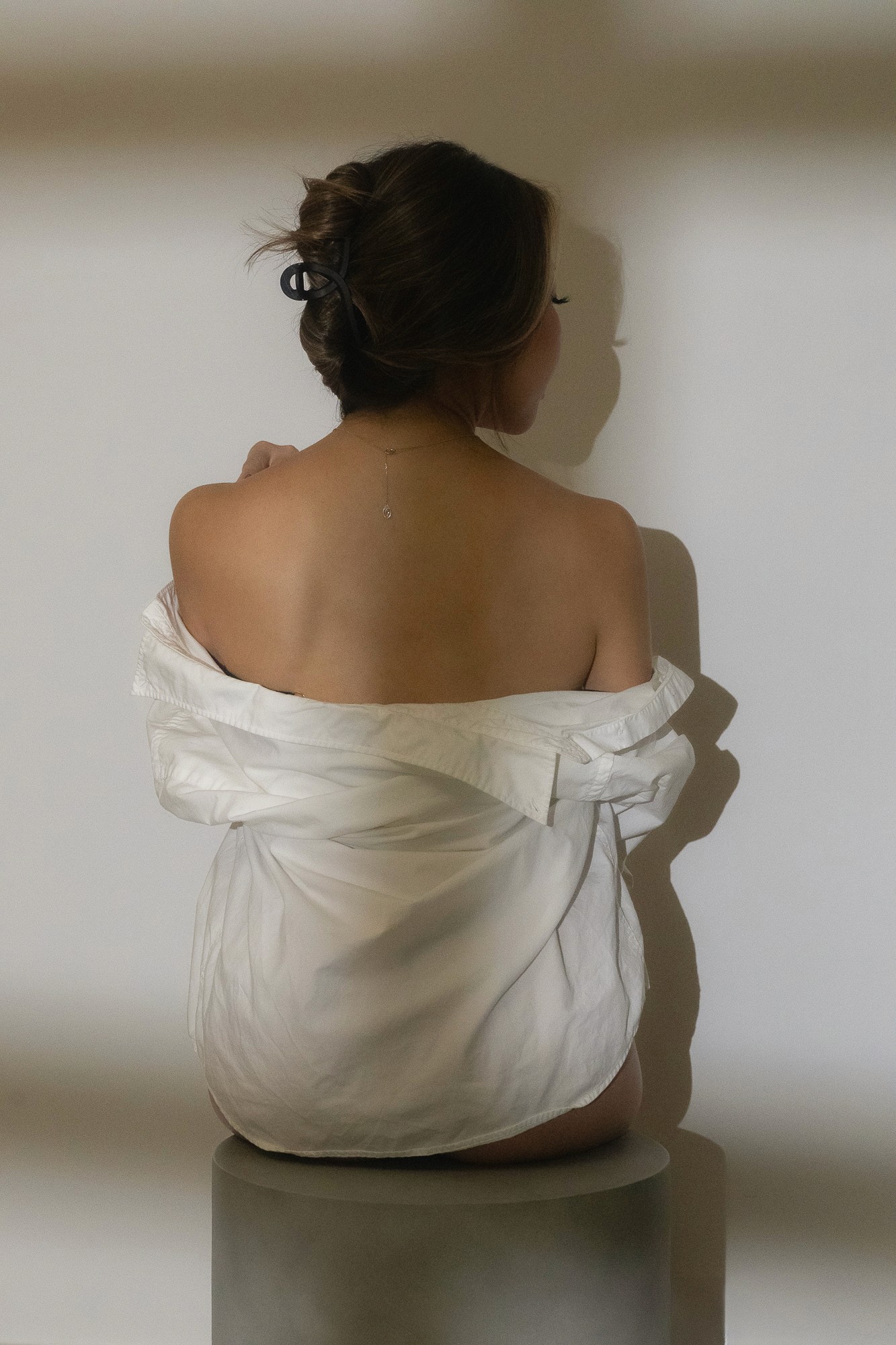 Silhouette of figure holding glasses