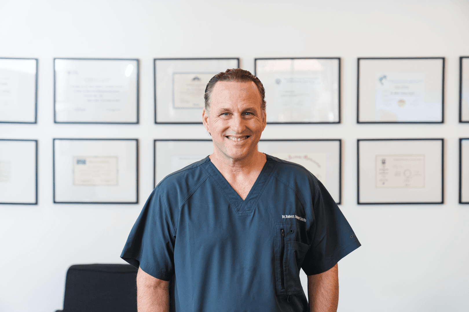 A man stading with Surfboard
