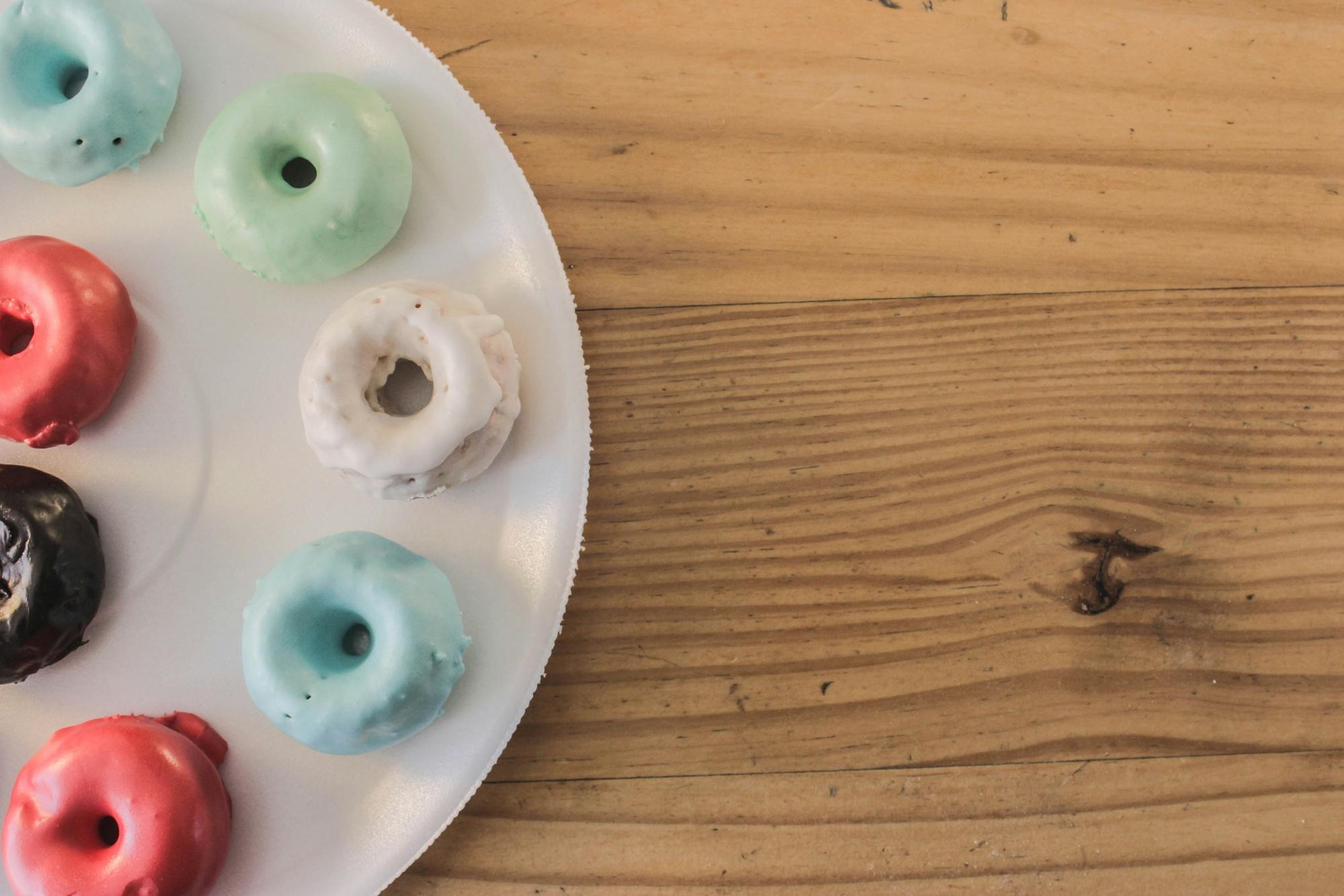 A range of colorful organic and vegan gummy vitamins on a wooden table, highlighting diverse consumer choices