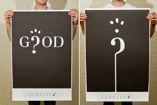 The image shows two side-by-side posters held up against a light-colored brick wall. The left poster has a black background with the word "GOD" in large white letters and a white question mark above it, accented by small white dots. The bottom right corner of the poster includes small white text reading "ILLUMINATED ATHEIST". The right poster has a black background with a white question mark on a white vertical line, also accented by small white dots. The posters appear to be made of a rigid material like poster board. Both individuals holding the posters are wearing white t-shirts.