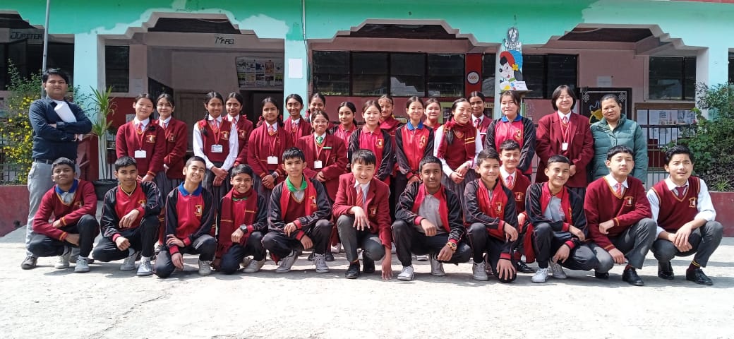 Three children jumping in burlap sacks during a race.
