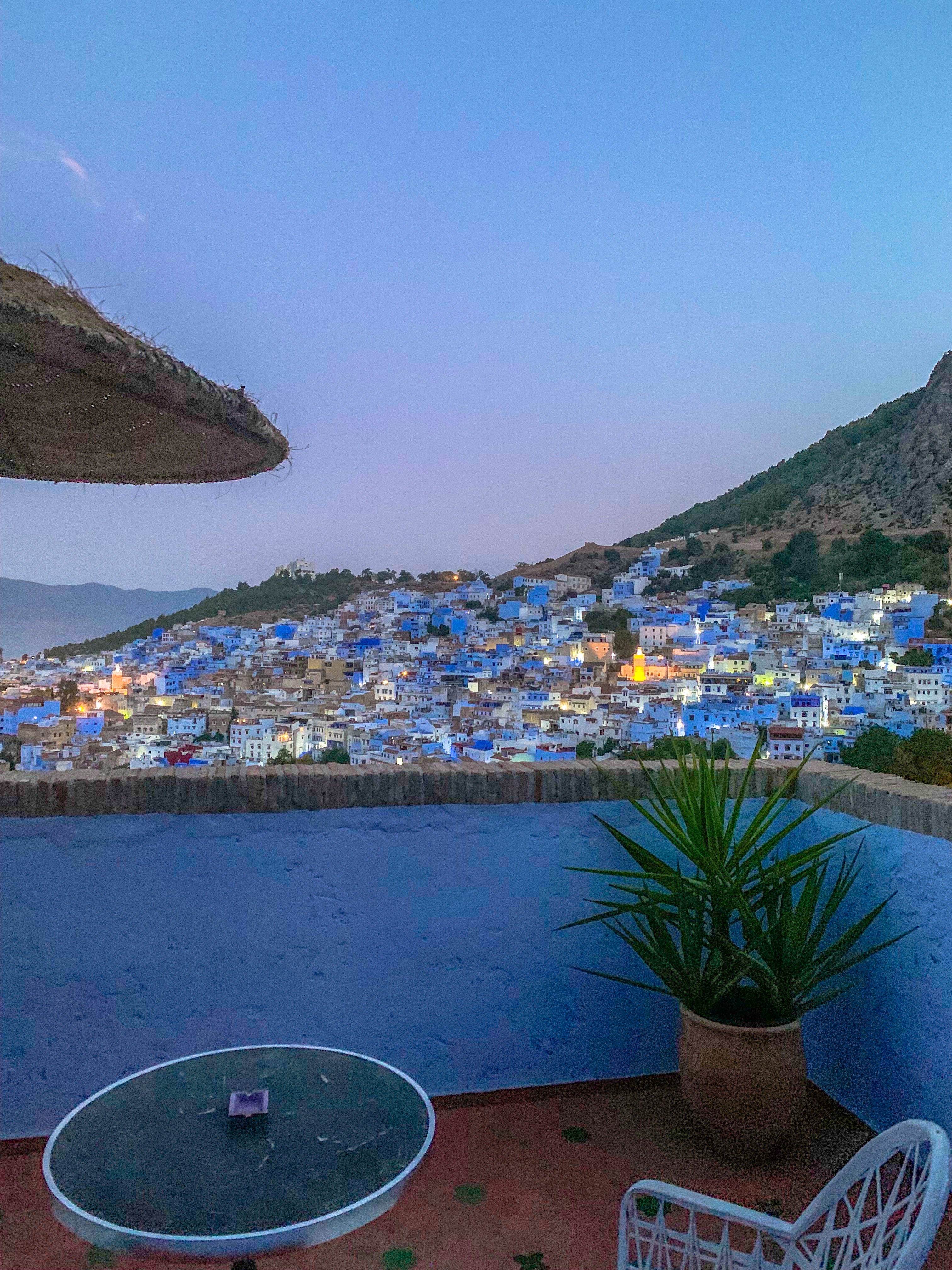 Close-up of two hands gently clasped, one wearing a sparkling engagement ring. The soft lighting and pastel nails evoke a sense of romance and intimacy.