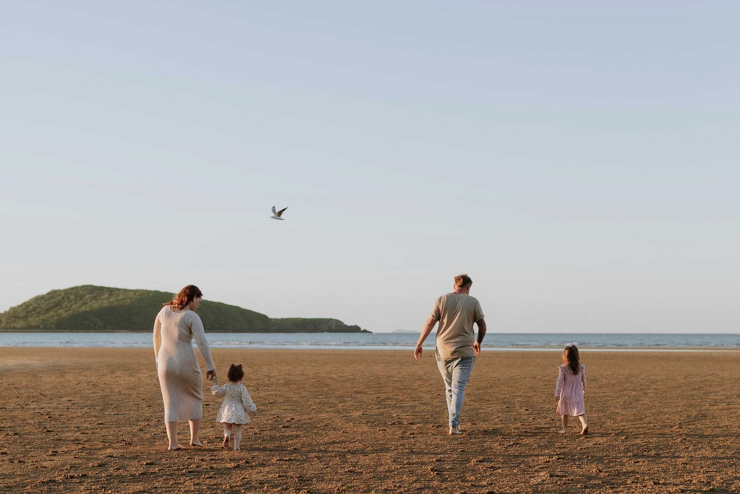 Family walking towards shoreline at the beach in Mackay