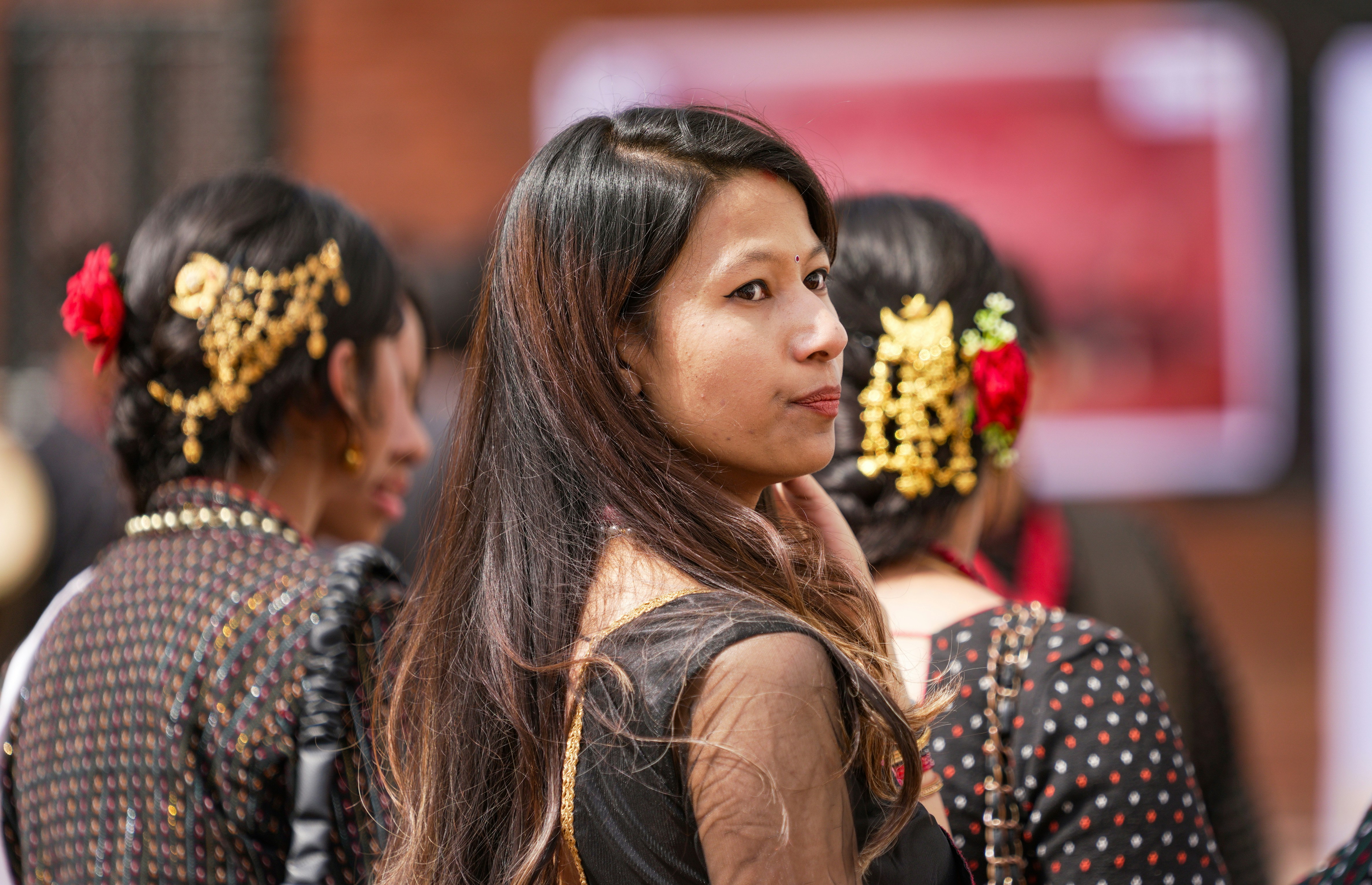 Young woman in traditional attire looks over shoulder