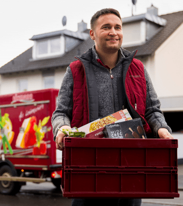 A man working on his laptop with various app icons floating around him.