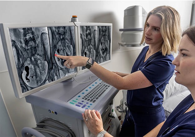 doctor pointing to computer screen with imaging