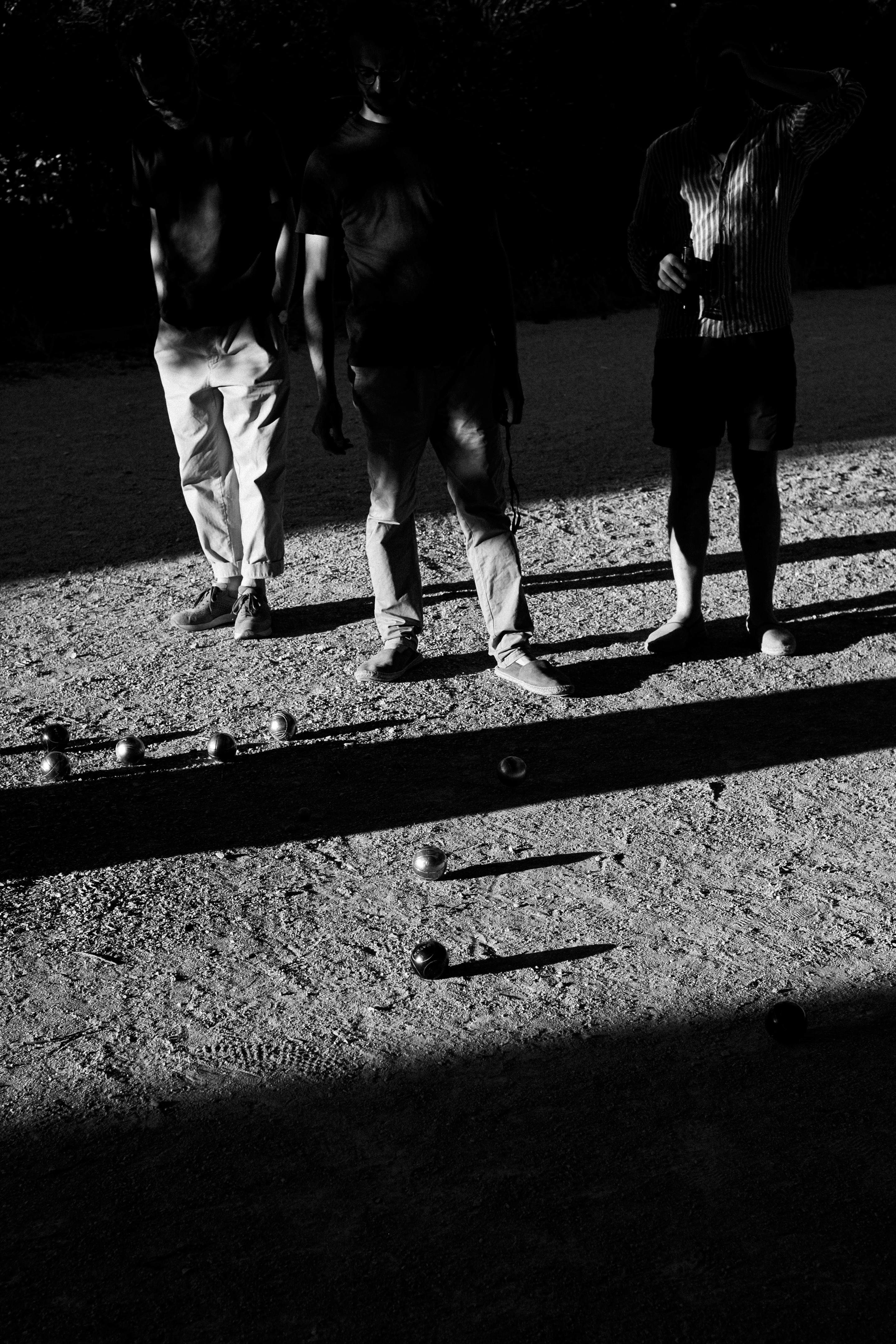 A sandy beach with a wind turbine in the background