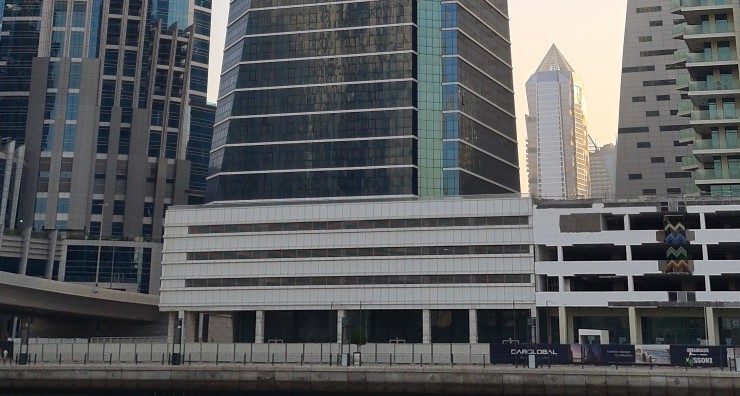 Podium and street-level view of Court Tower, featured by a professional real estate agent in Dubai.