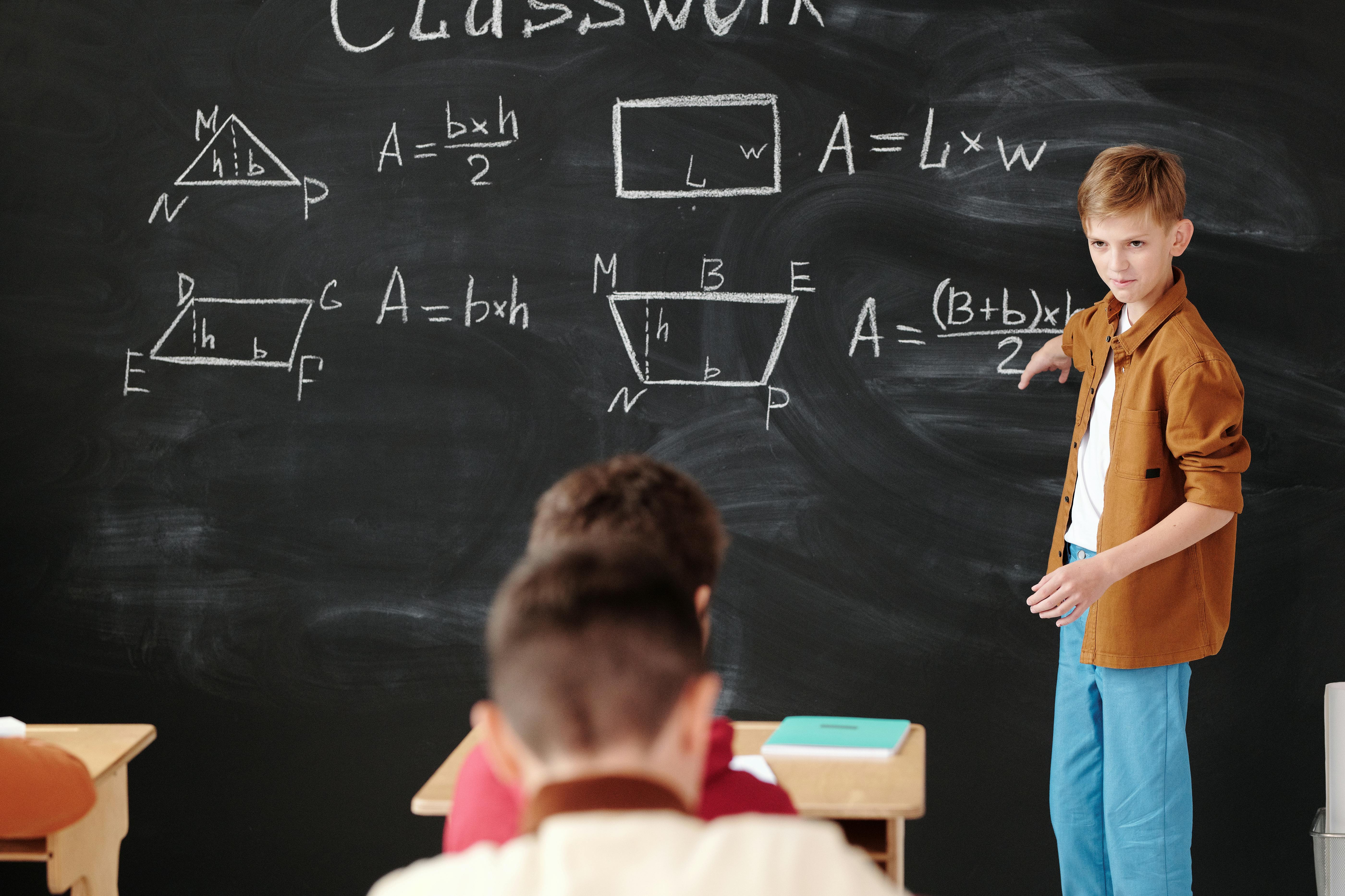 A Student Discussing in Front of the Blackboard