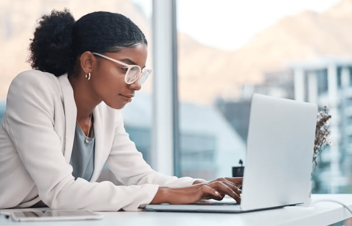 woman leaning into tech work at office