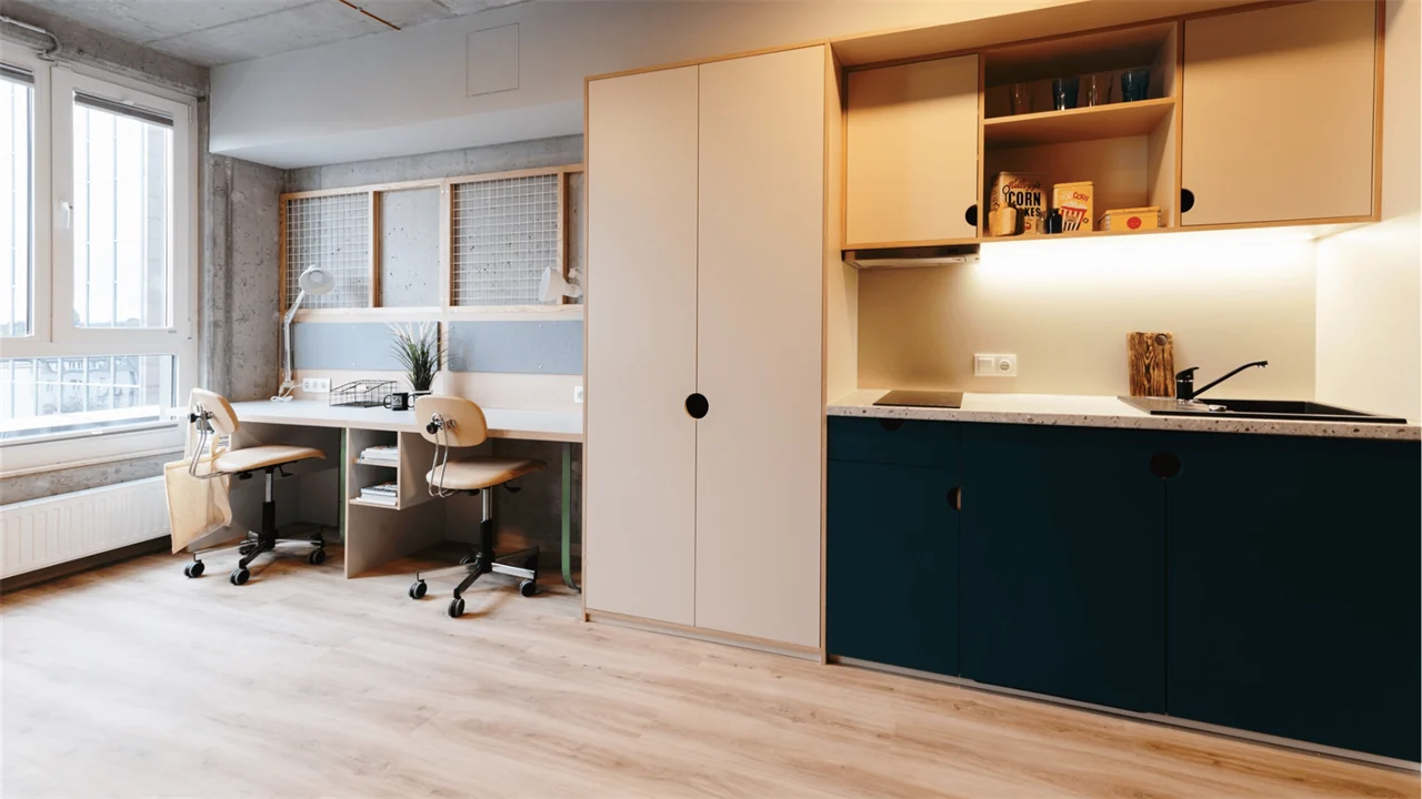 Shared student studio with two study desks and kitchenette in Kraków