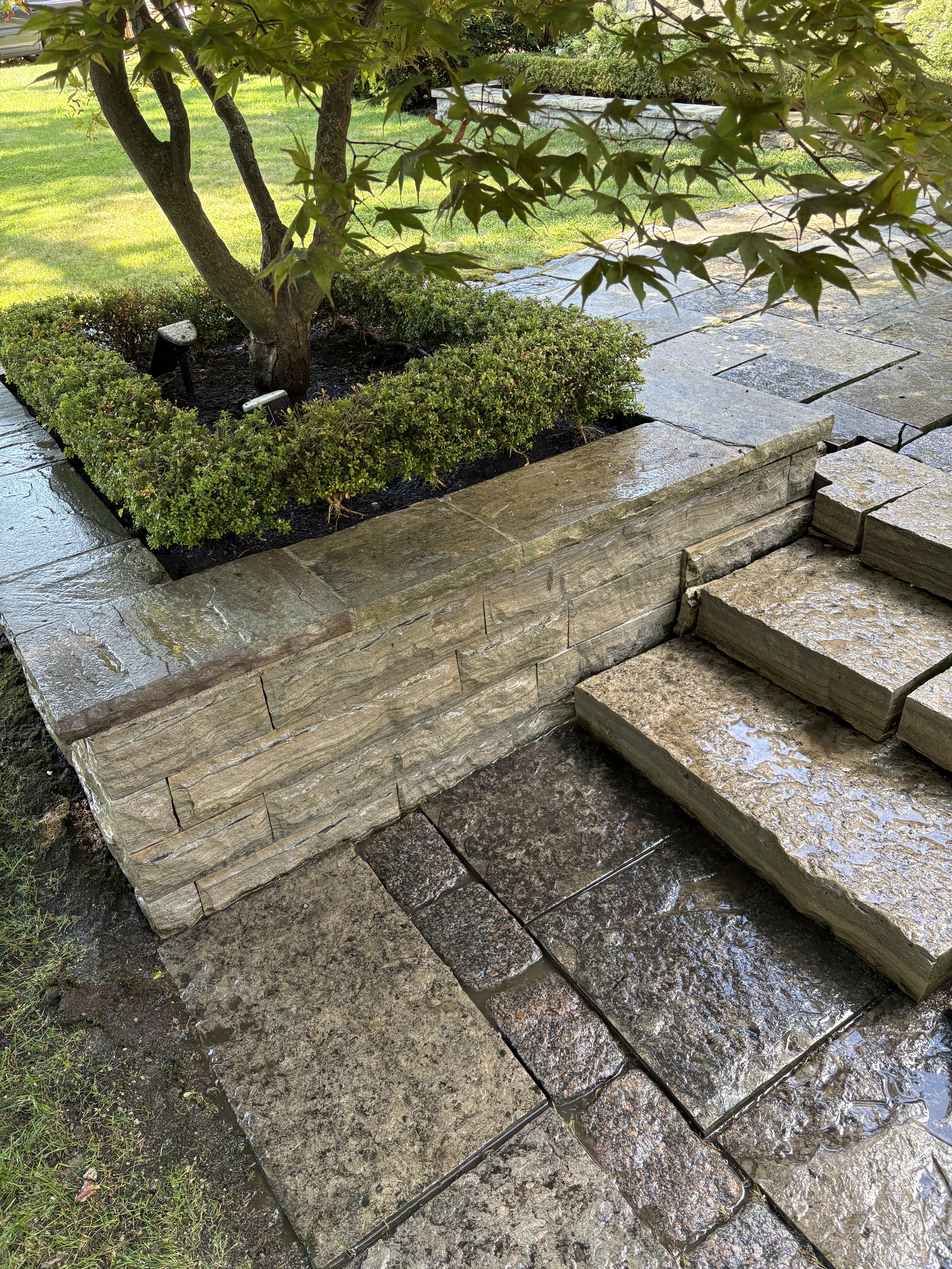 Flagstone steps and stone retaining wall after exterior pressure washing