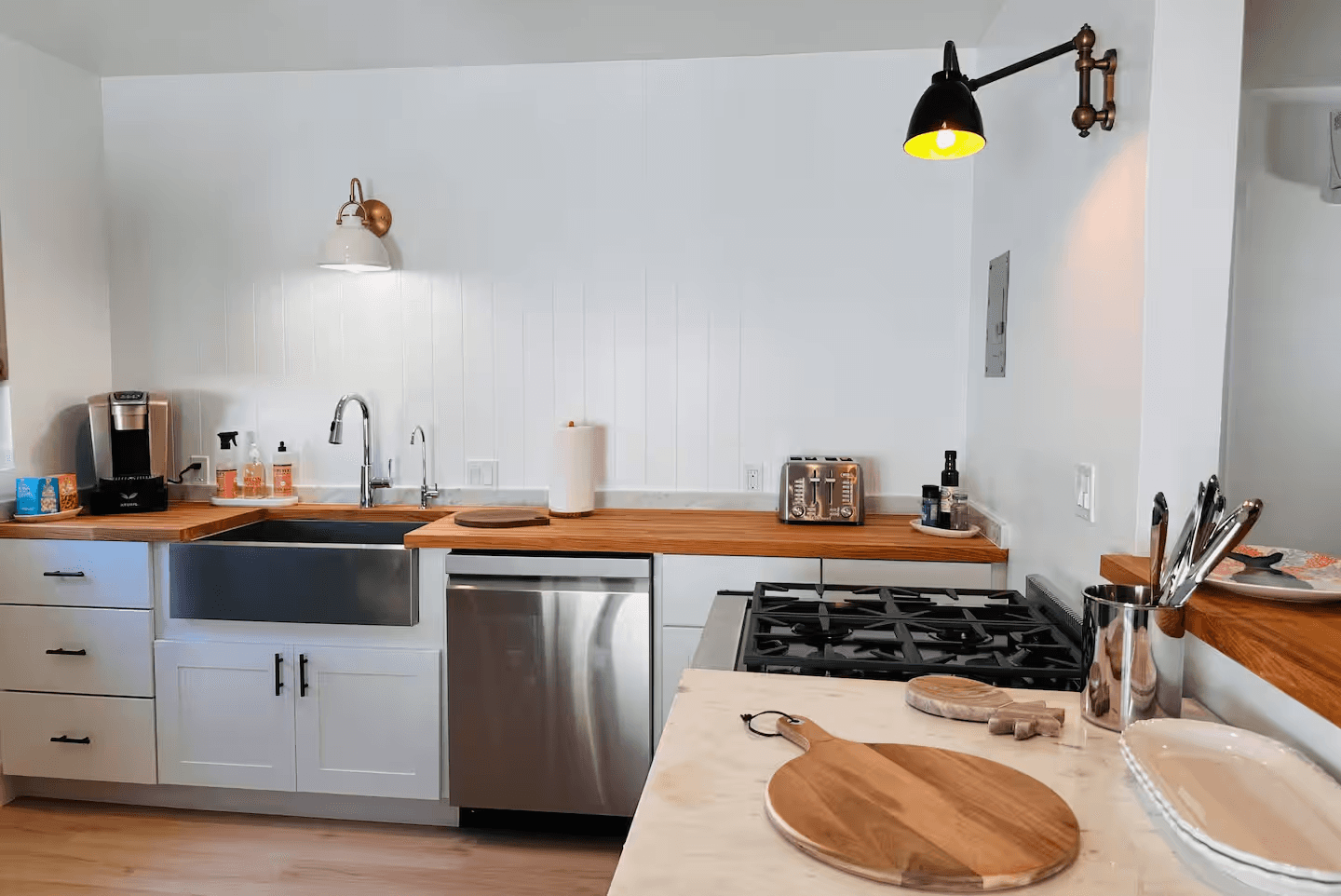 Full kitchen in Soul & Sea condo 8 with stainless steel appliances and wood counters