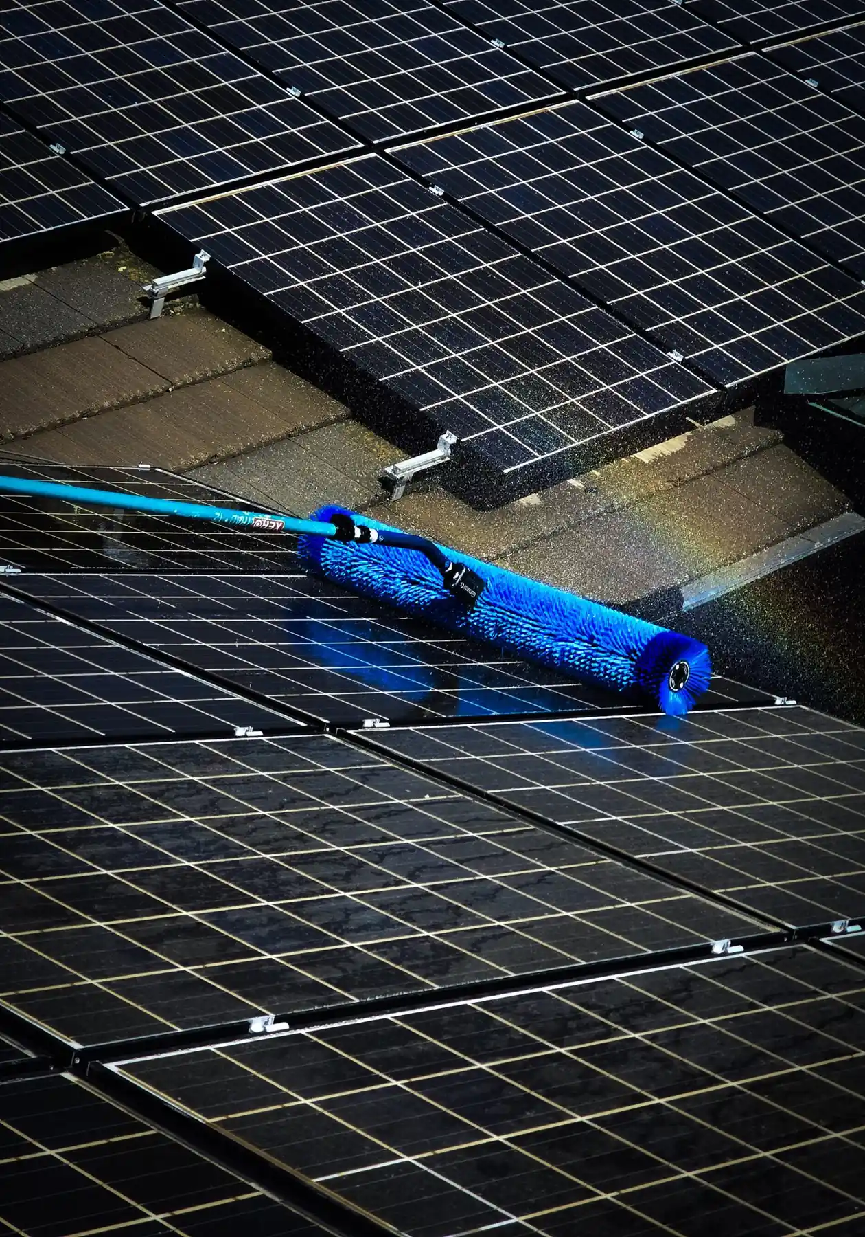 Blue rotary brush on a water-fed pole cleaning a residential array | Premier Solar Service, serving Fresno, CA