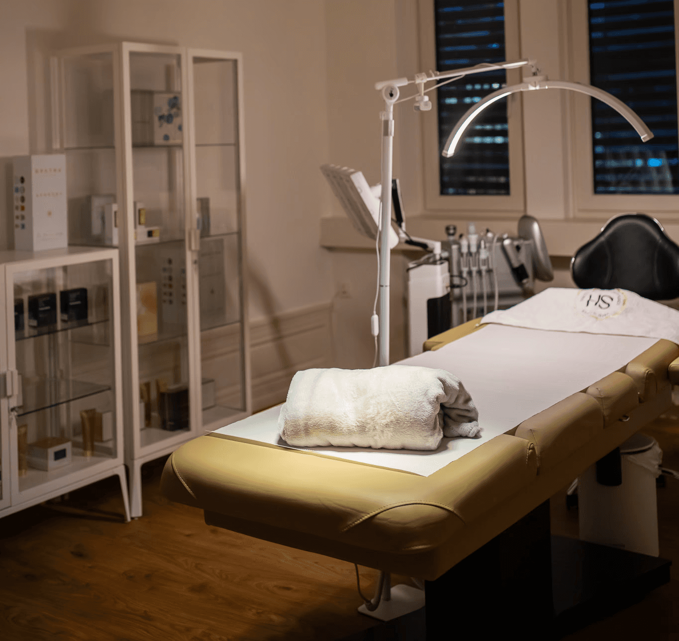 Portrait of a woman with short brown hair, eyes closed, gently holding her face