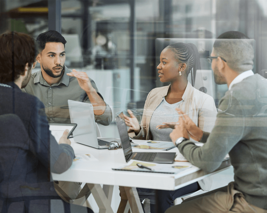 A photo that describes a Peer Network program on Horizon Search, showing 4 people sitting around a table and discussing in an office.