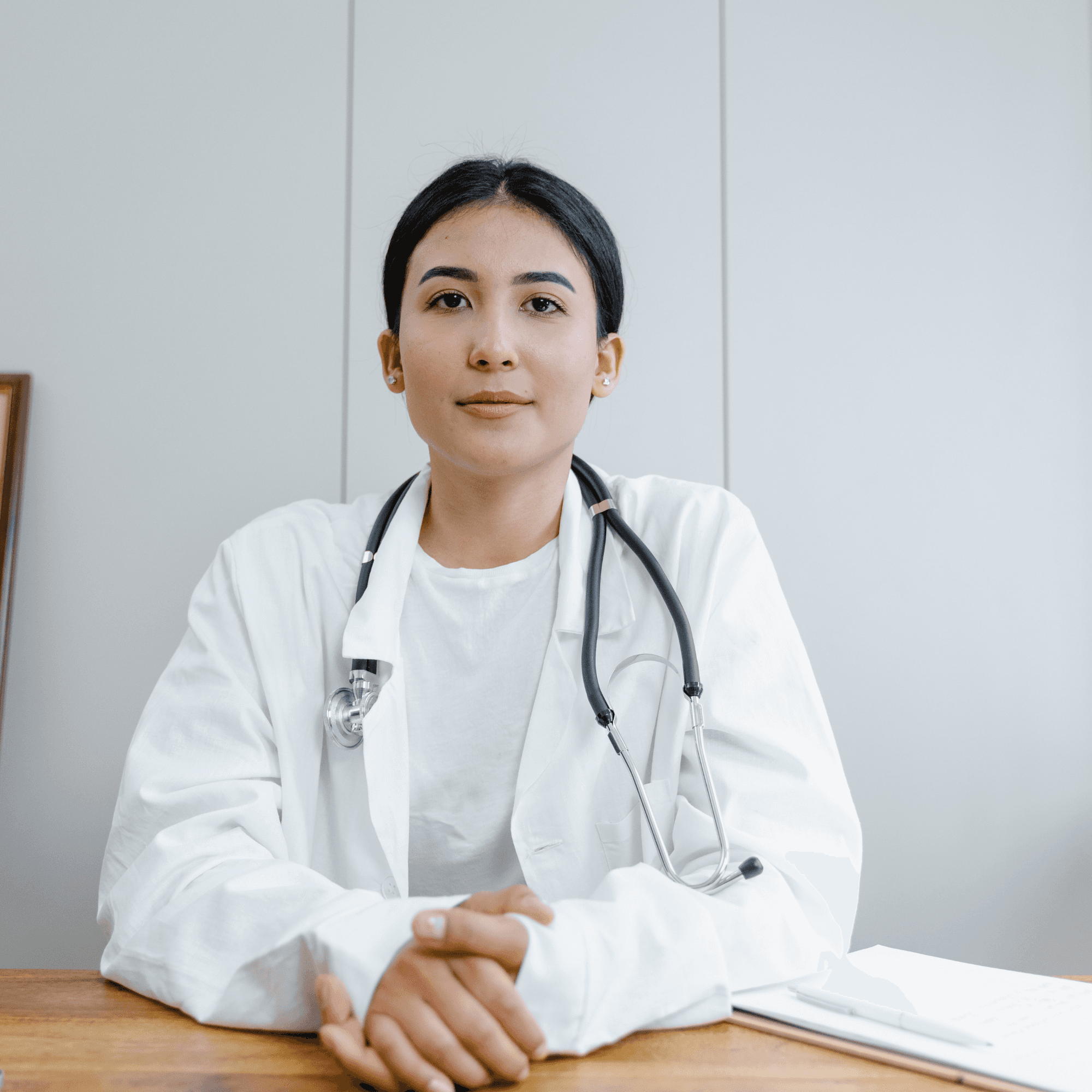 Female doctor in an Irish hospital wearing a white coat and stethoscope.