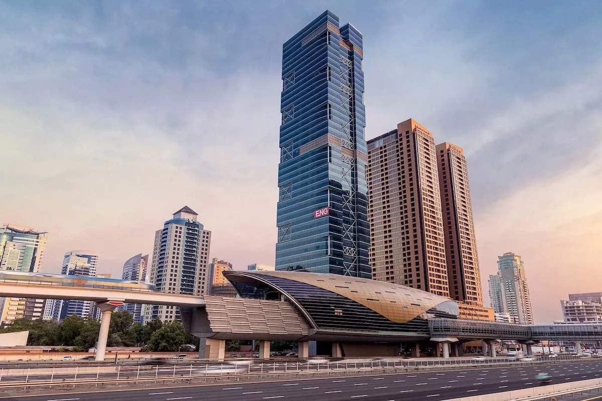 Scenic evening view of The One Tower and nearby Metro station, perfect for real estate accessibility.