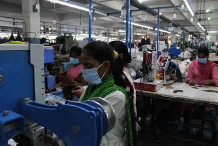 People working in the factory on machines