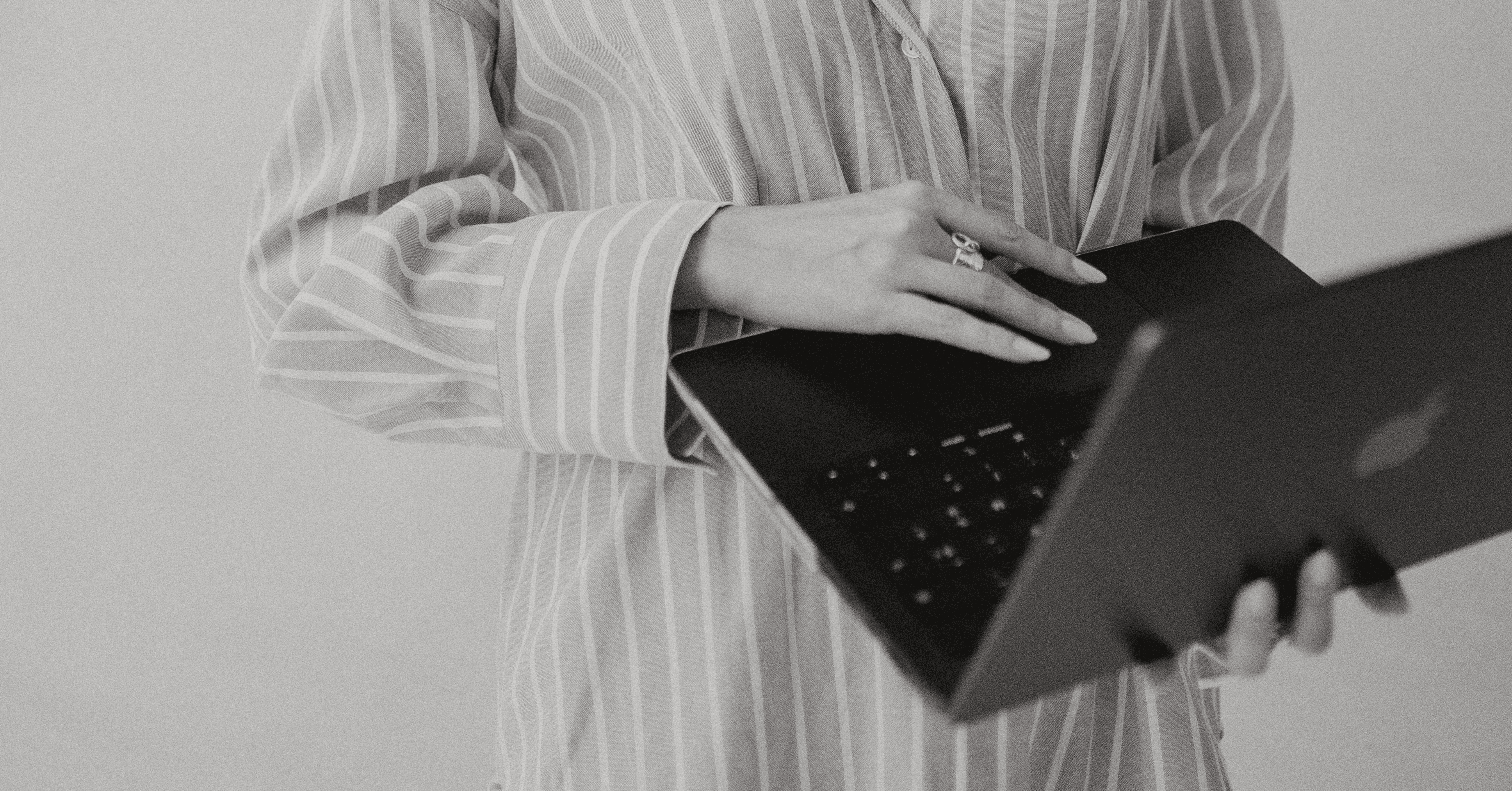 A close-up of a beige-colored laptop with a smooth, matte finish on a matching surface.