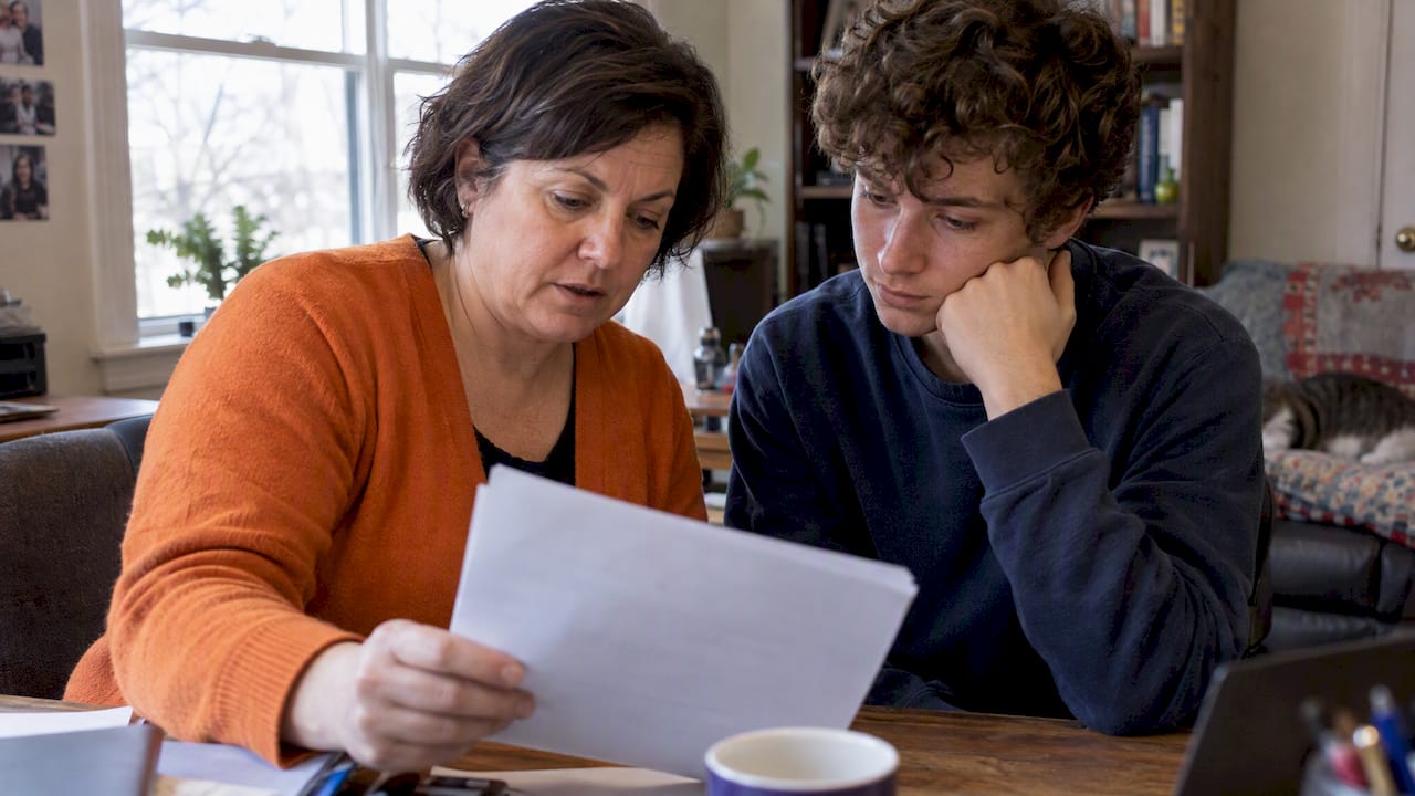 Parent and autistic young adult reviewing SSA notice