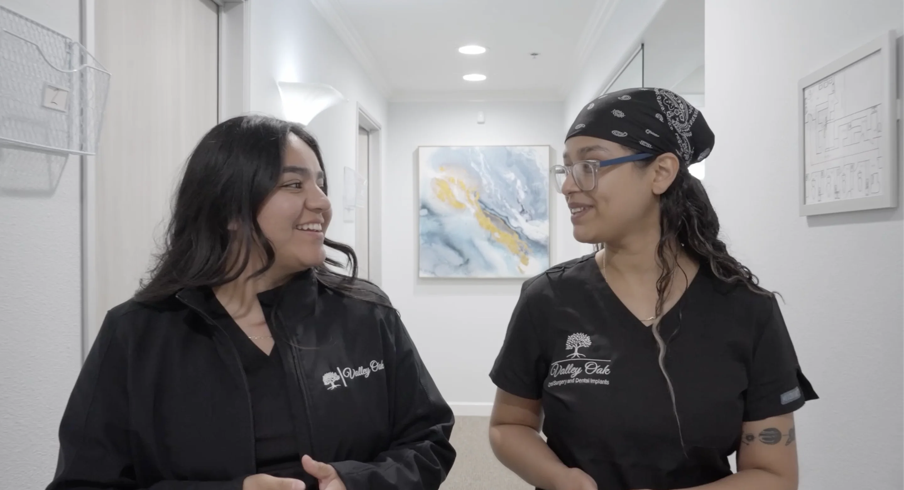 Friendly oral surgery team members welcoming patients inside a modern dental implant and oral surgery office in Fresno, CA