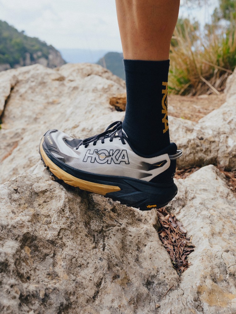 Close-up of a HOKA Mafate 5 trail shoe stepping onto a limestone rock