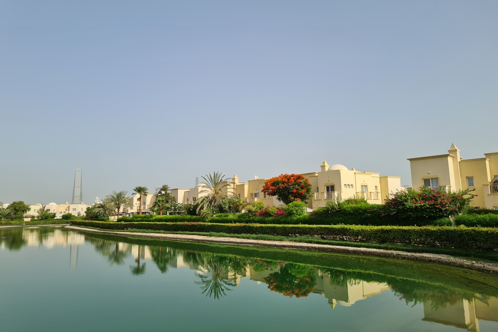 Serene water body, Springs 2 community: lush greenery, clear sky reflection.