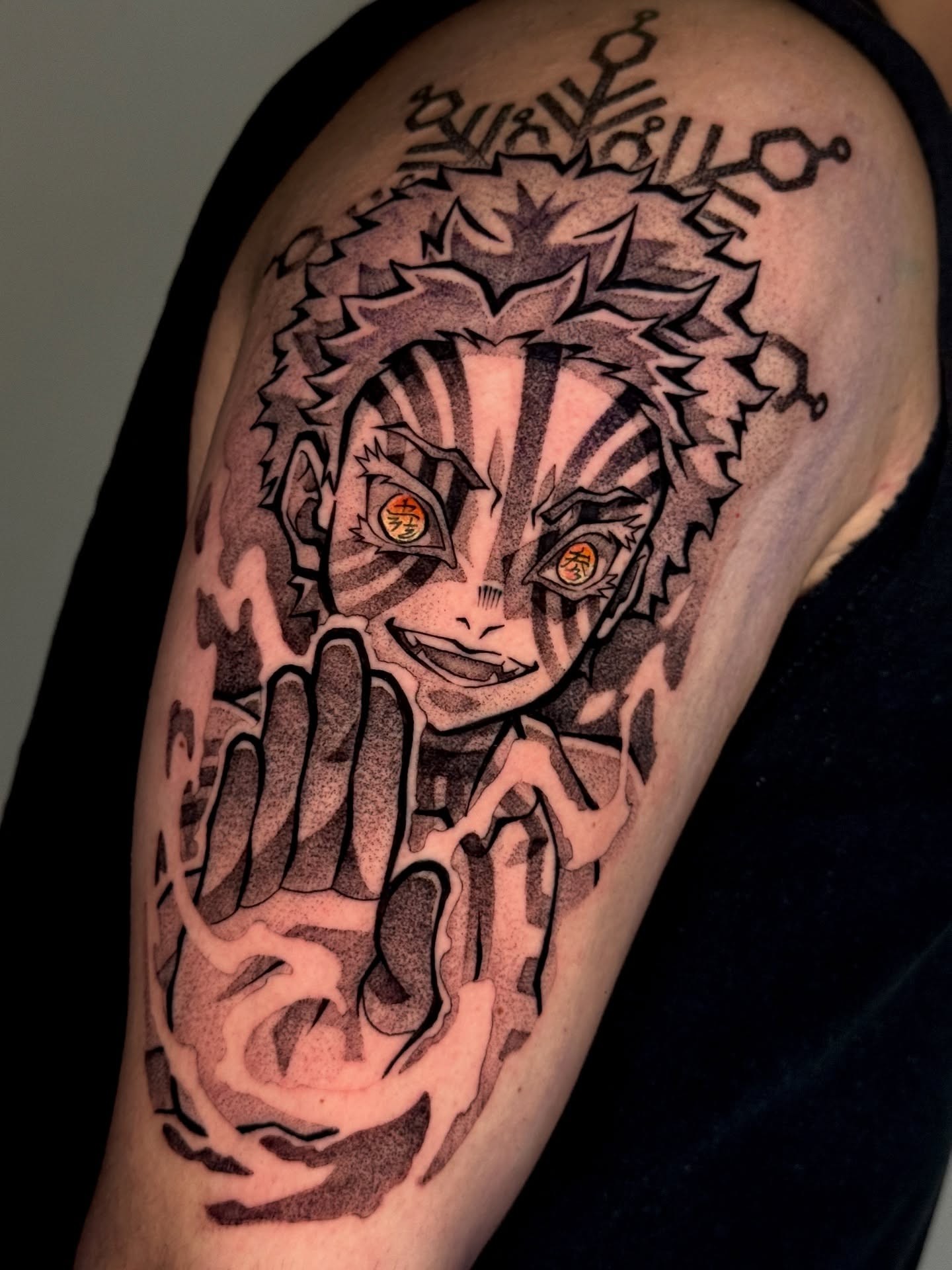 A forearm tattoo of Nezuko Kamado from Demon Slayer, depicted in a stylized anime art style. She is holding a sword.