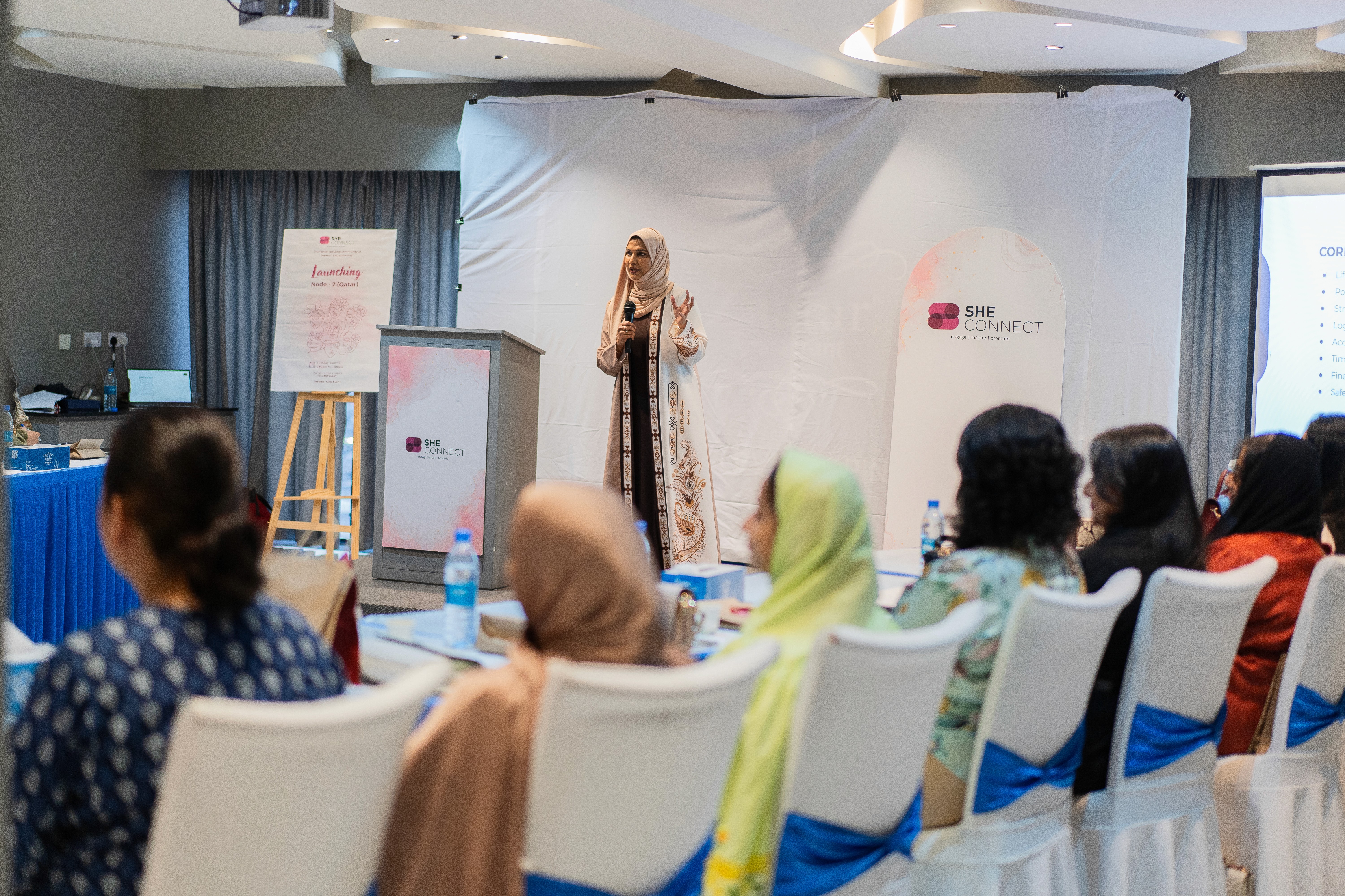 Close-up of a dark green leaf showing its textured surface and central vein against a muted background.