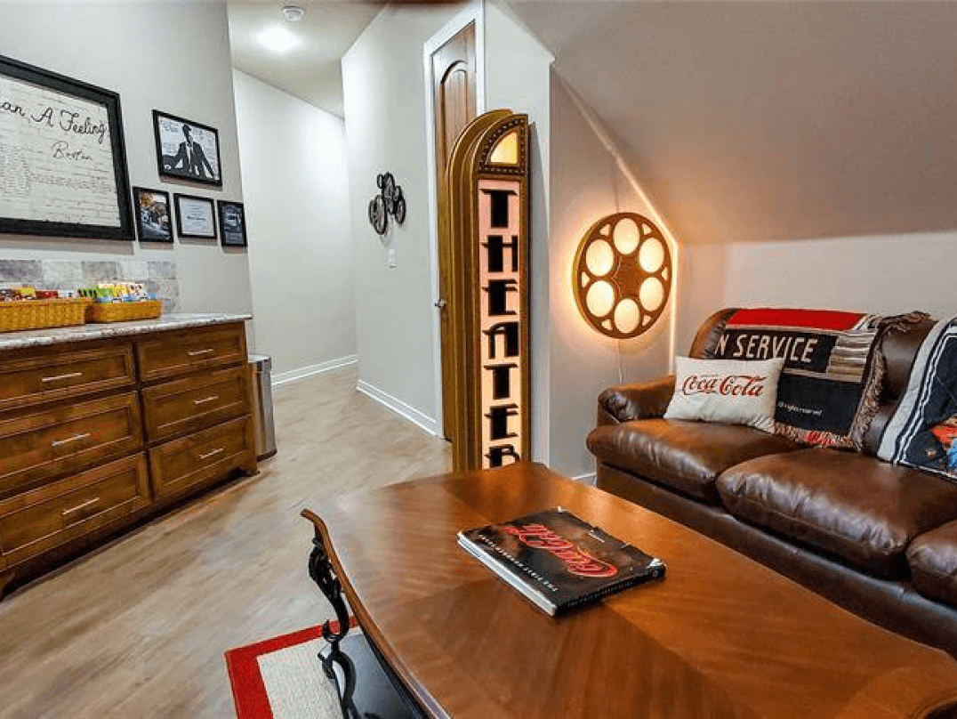 Bonus room with a leather sofa and built-in bookshelf