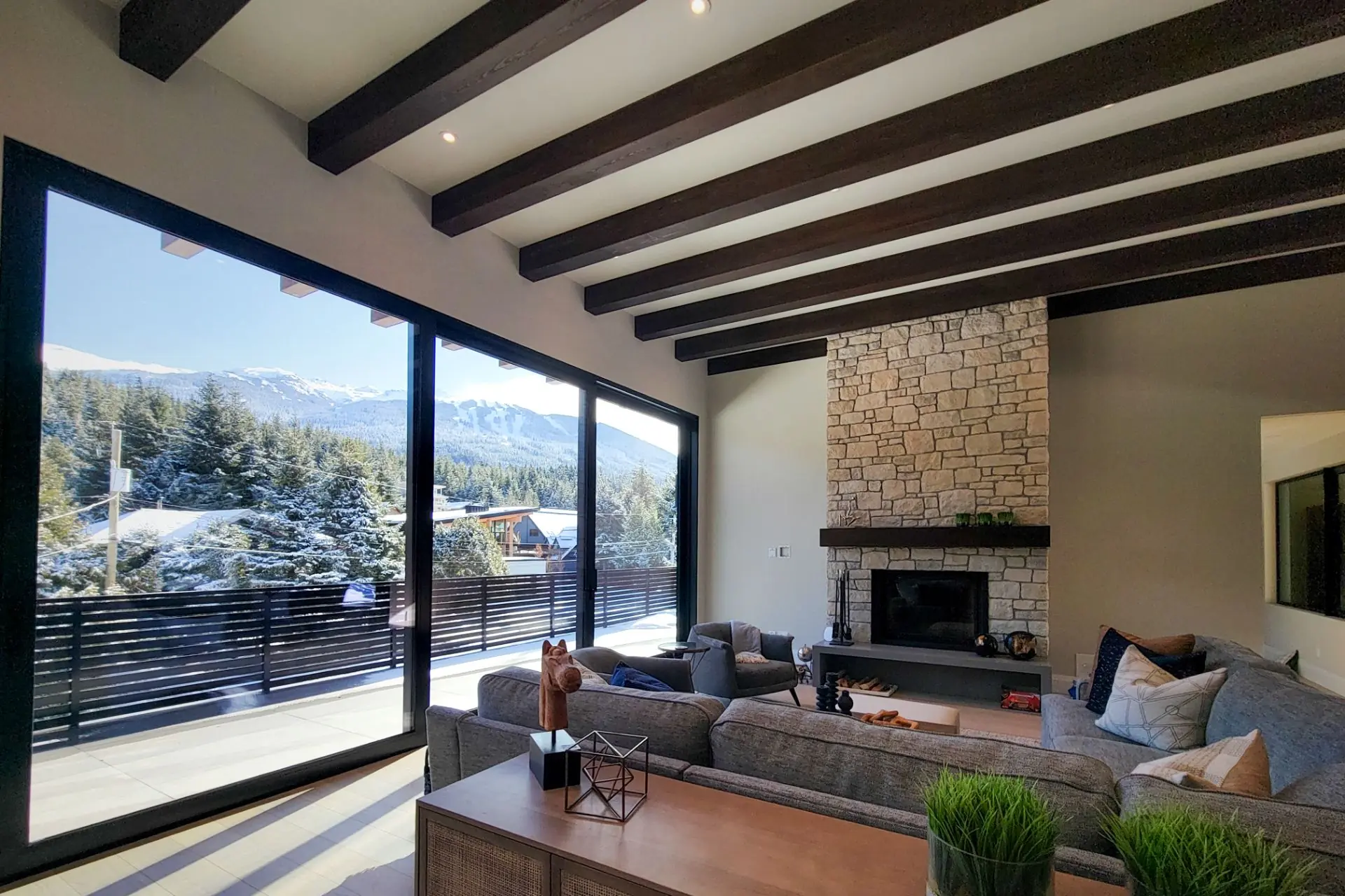 Exterior of the White Gold custom home in Whistler showing its stone, wood, and metal facade.