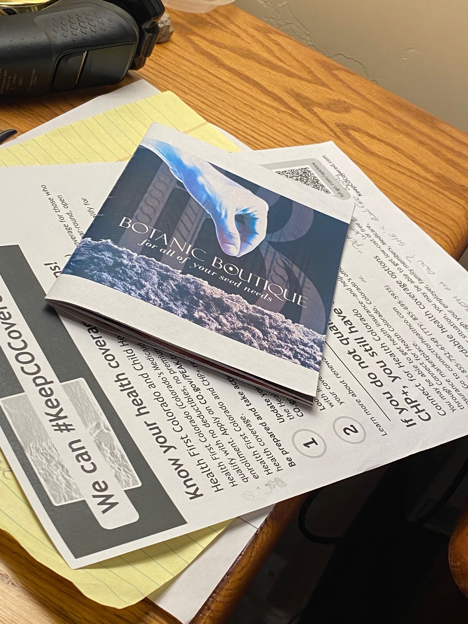 life photo of catalog laying on a table among other items.